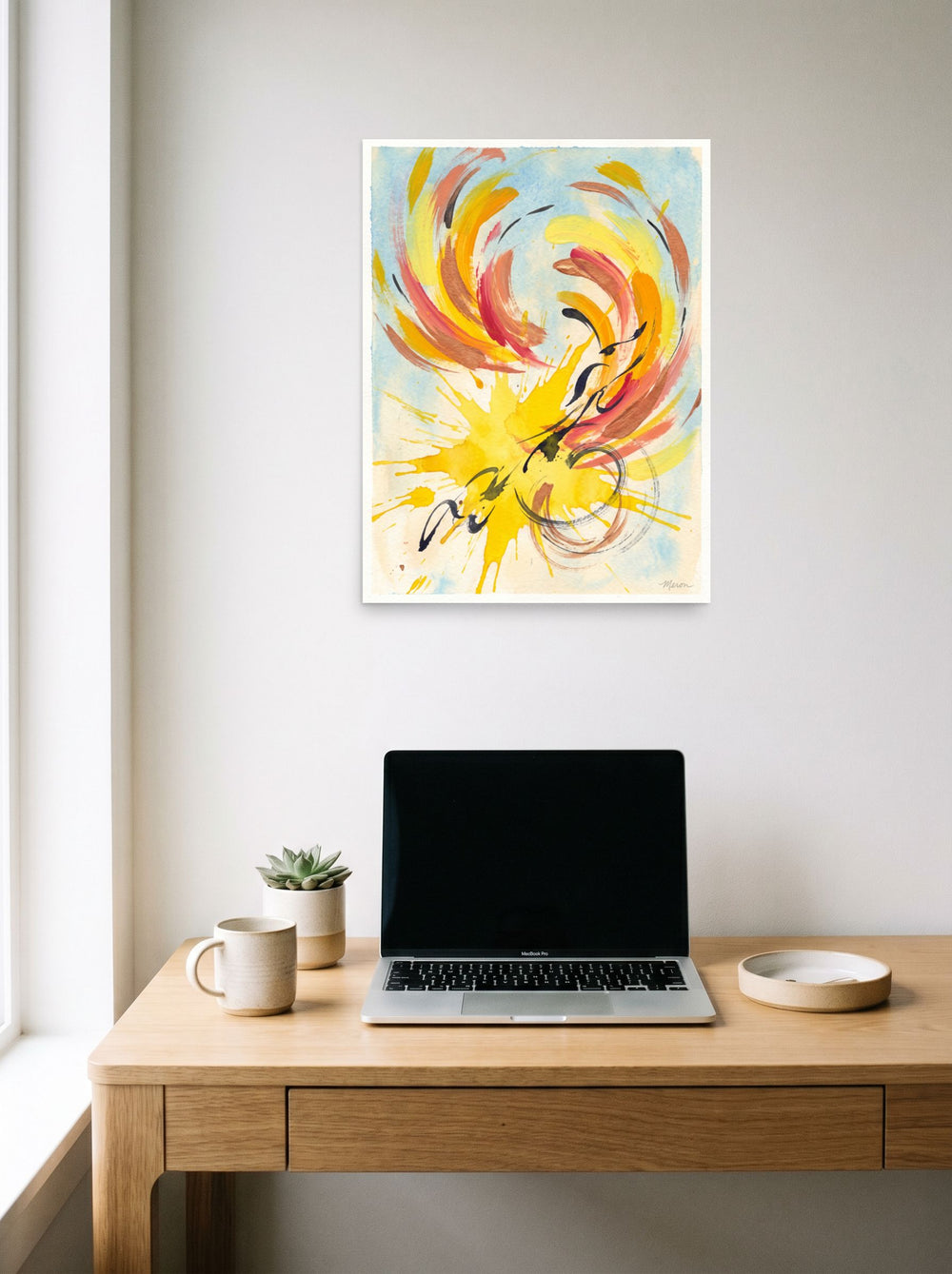 'Solstice Flight' in 18x24 inch unframed paper, hanging above a worktable with a laptop.