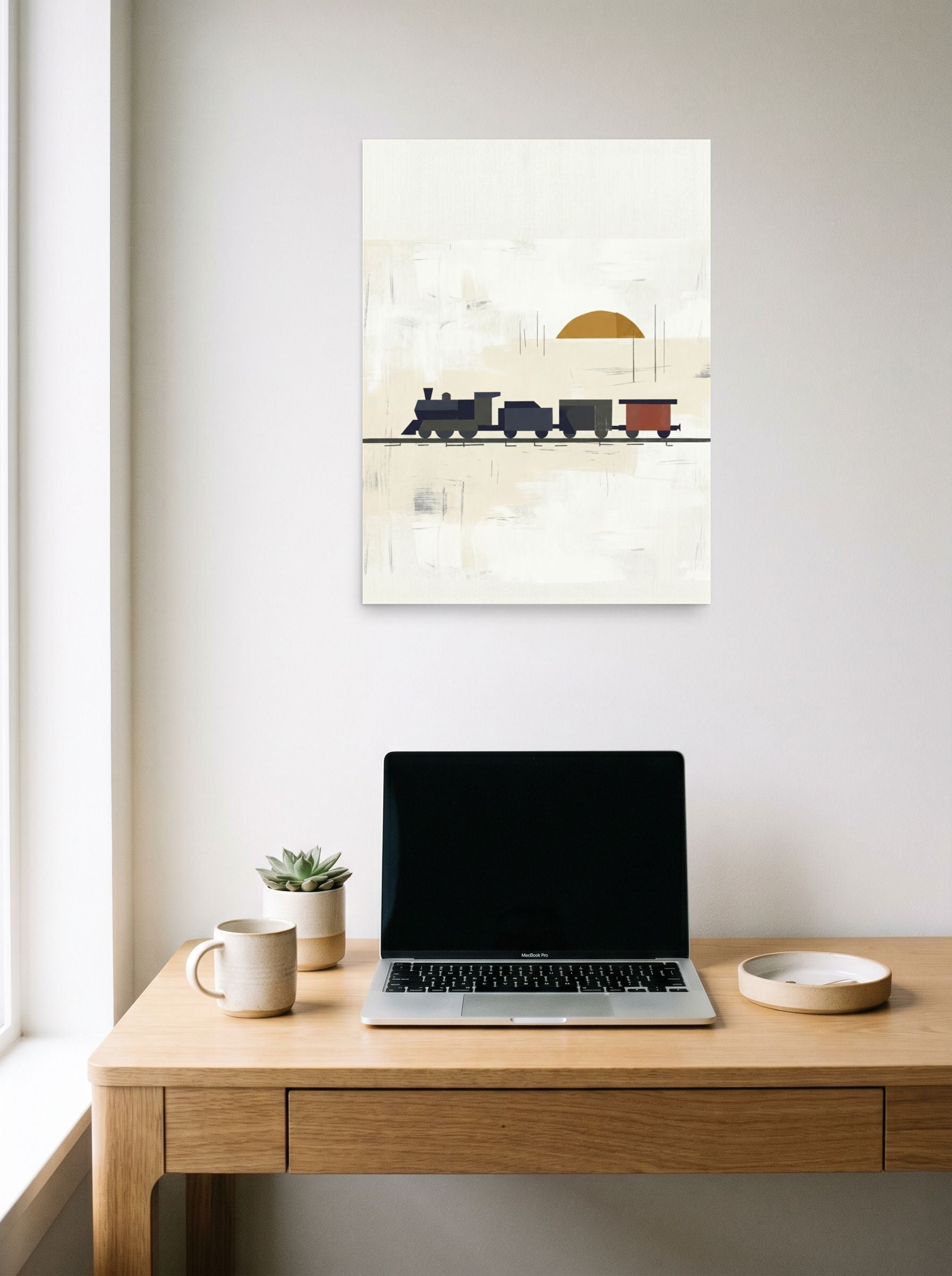 A 18x24 inch unframed paper Minimalism print of 'Sunrise Locomotive' hanging above a worktable with a laptop.