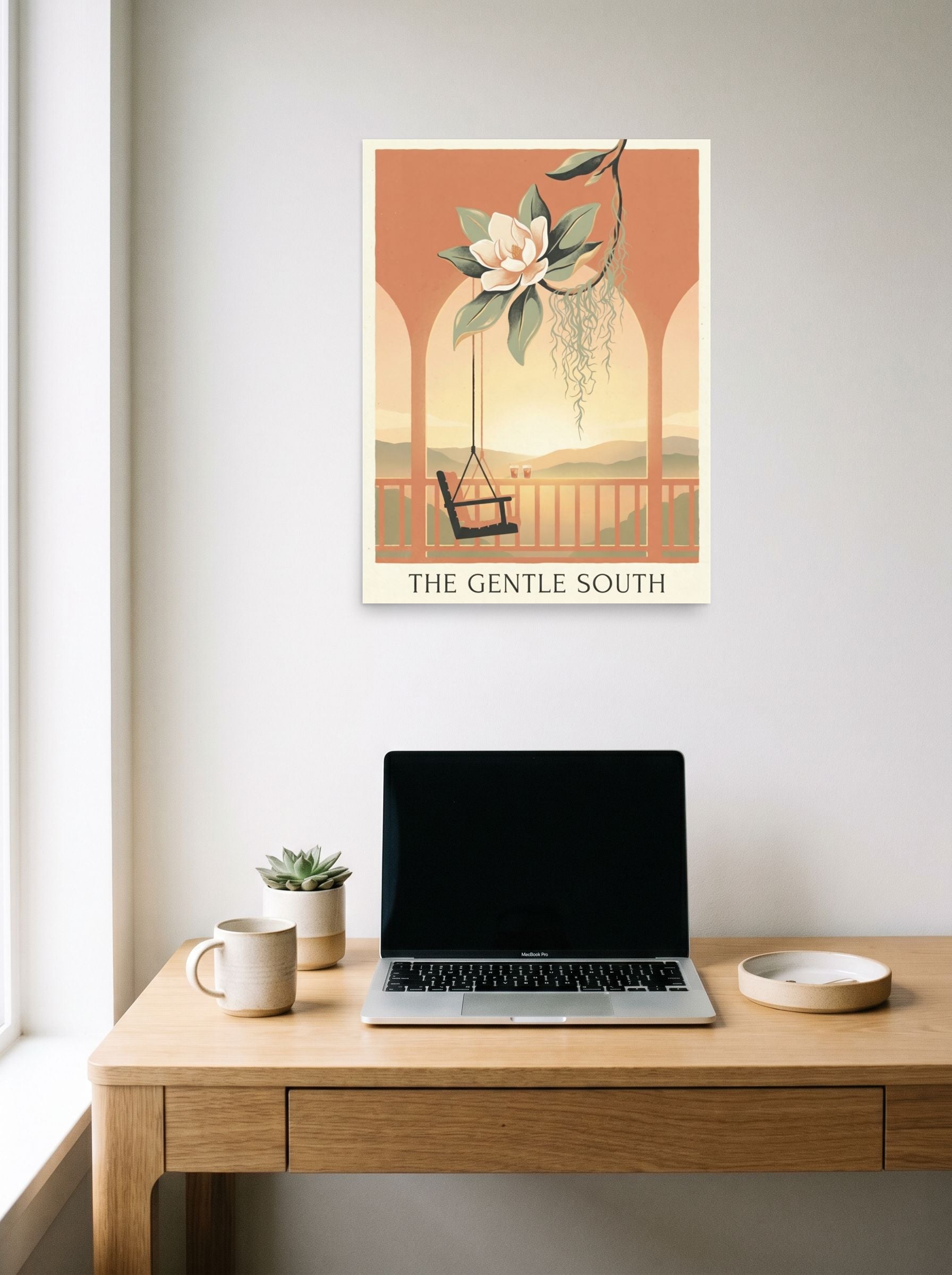A 18x24 inch unframed paper Art Nouveau,Digital art print of 'The Gentle South' hanging above a worktable with a laptop.