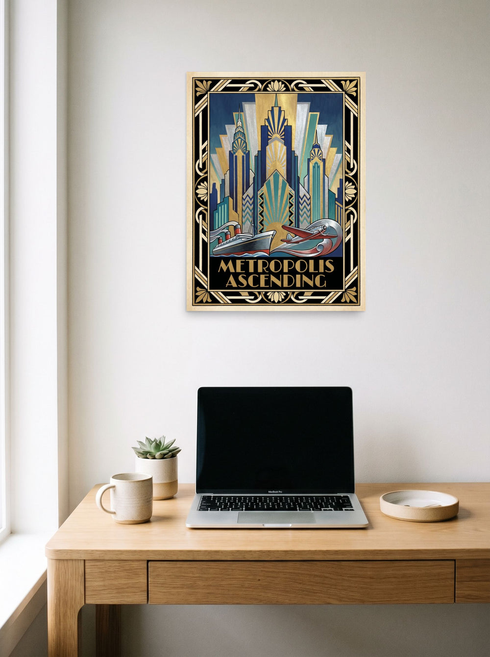 A 18x24 inch unframed paper Art Deco print of 'Metropolis Ascending' hanging above a worktable with a laptop.