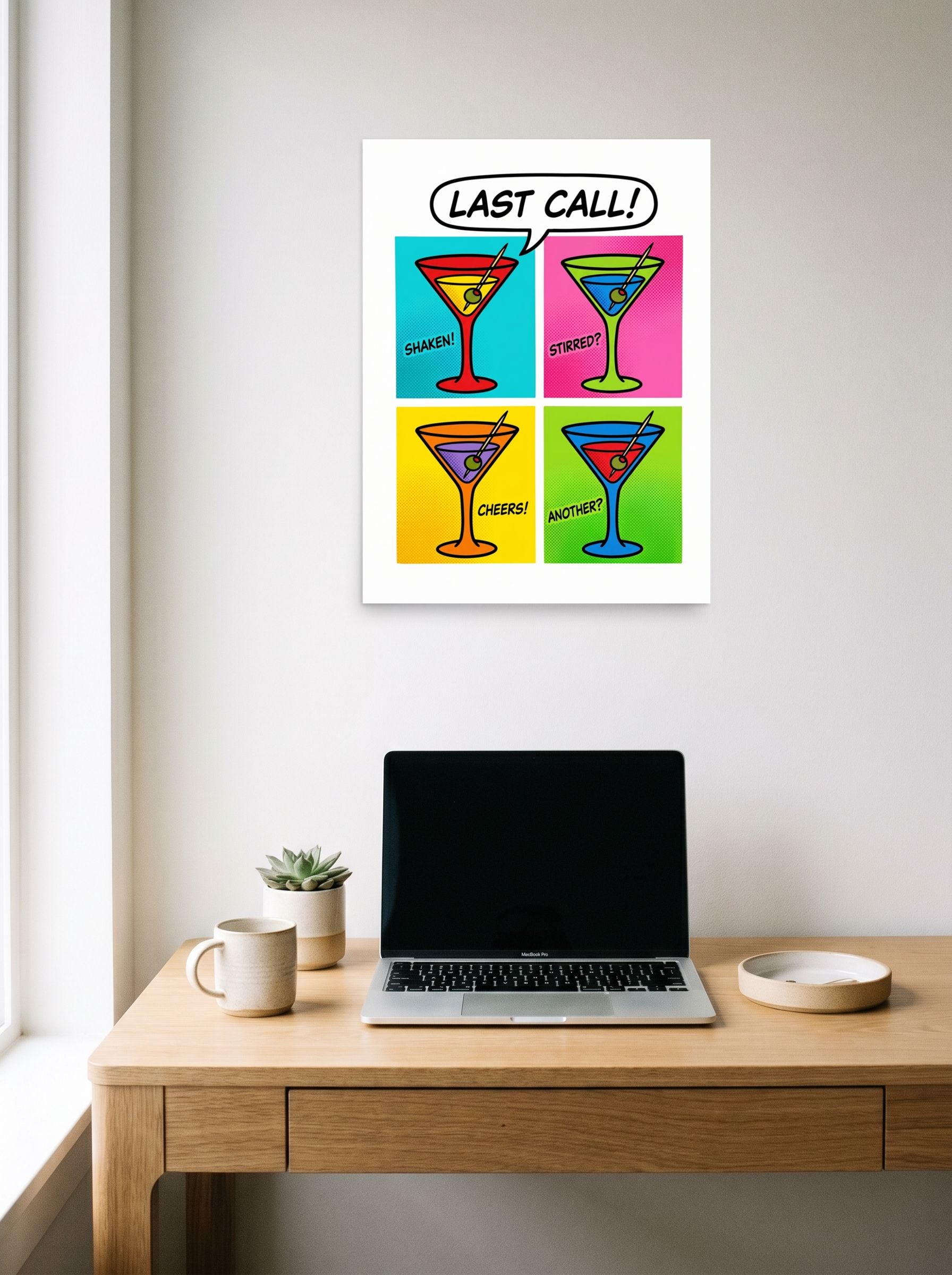 A 18x24 inch unframed paper Pop art print of 'Last Call' hanging above a worktable with a laptop.