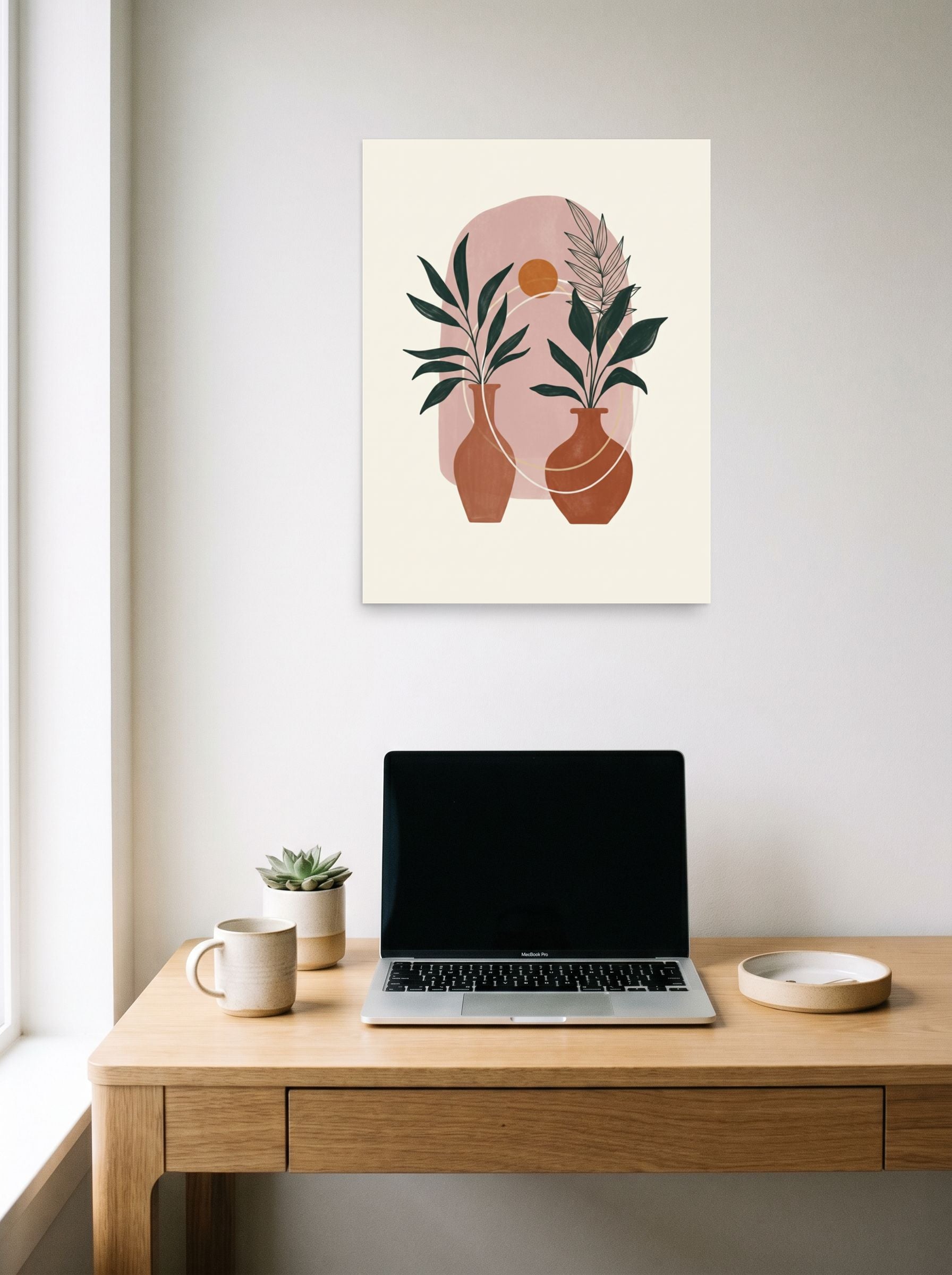 A 18x24 inch unframed paper Minimalism print of 'Desert Oasis Botanicals' hanging above a worktable with a laptop.