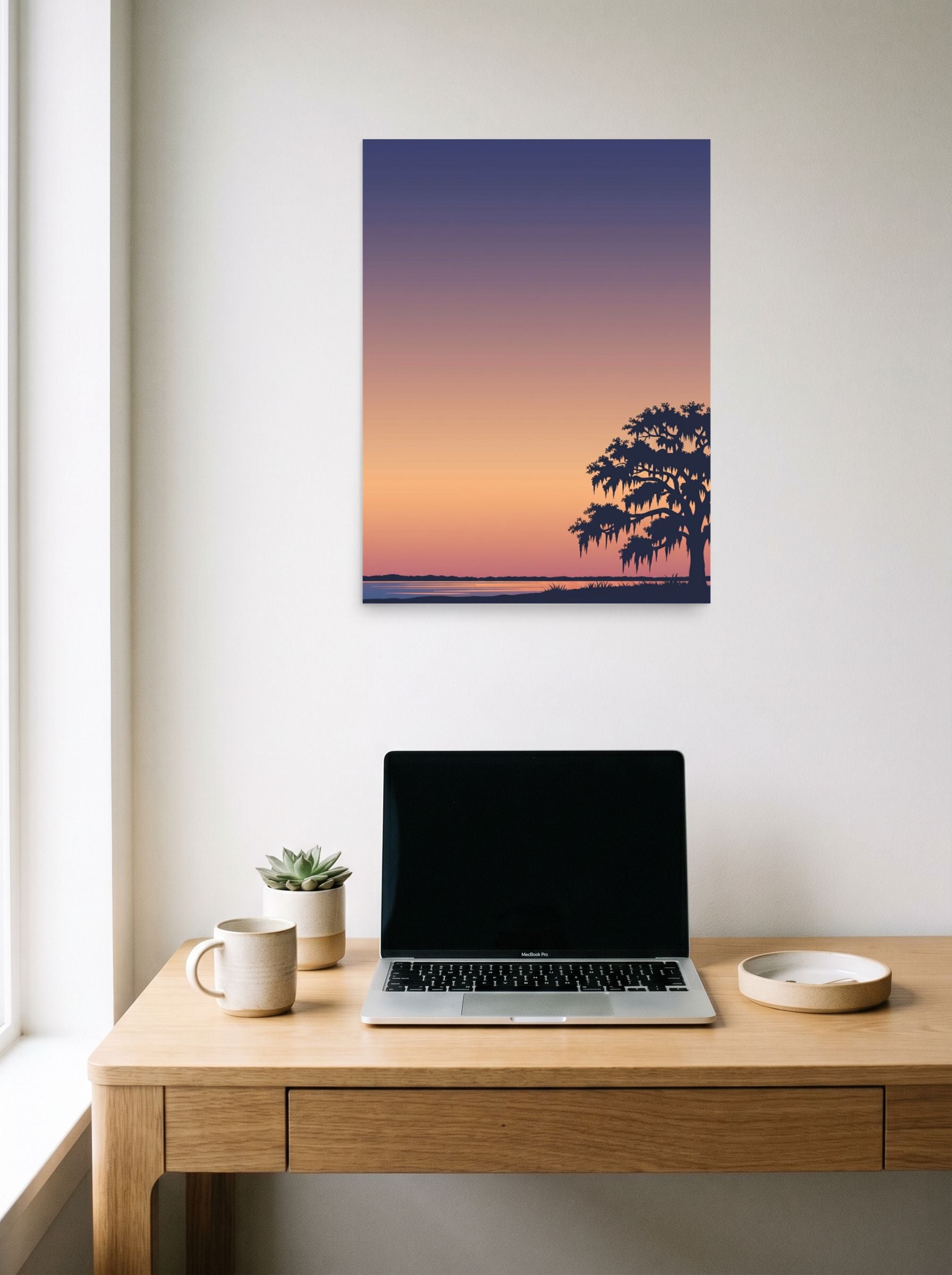 A 18x24 inch unframed paper Digital art,Minimalism print of 'Twilight Tranquility' hanging above a worktable with a laptop.
