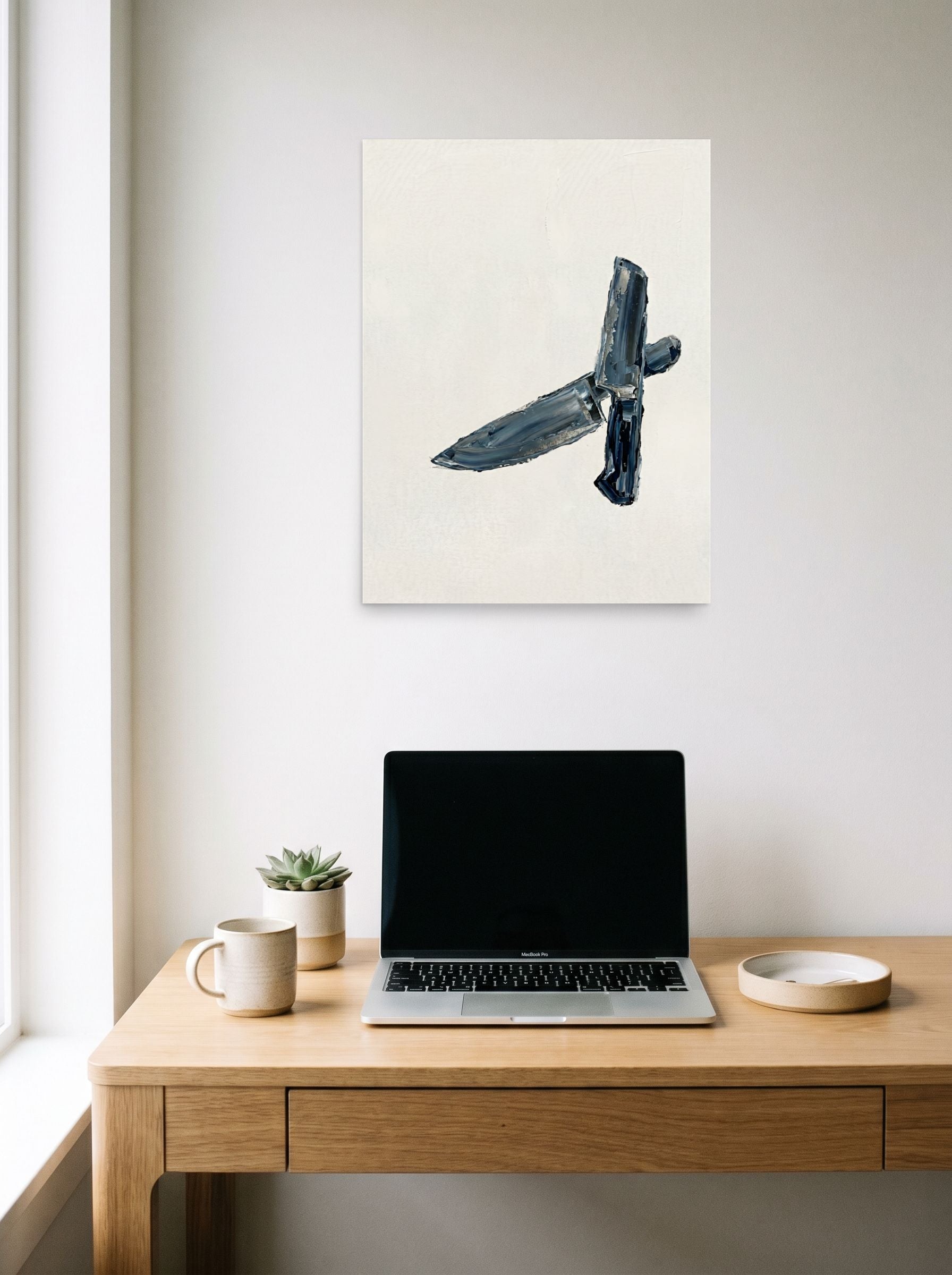 A 18x24 inch unframed paper Minimalism print of 'Culinary Precision' hanging above a worktable with a laptop.