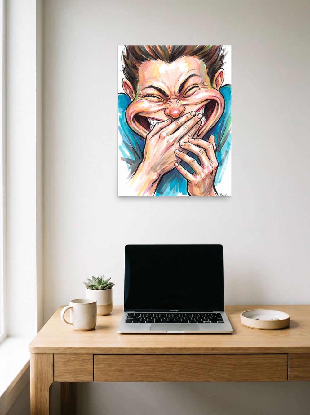 Mockup of 'Burst of Laughter' as a 18x24 inch unframed paper print, hanging above a worktable with a laptop.