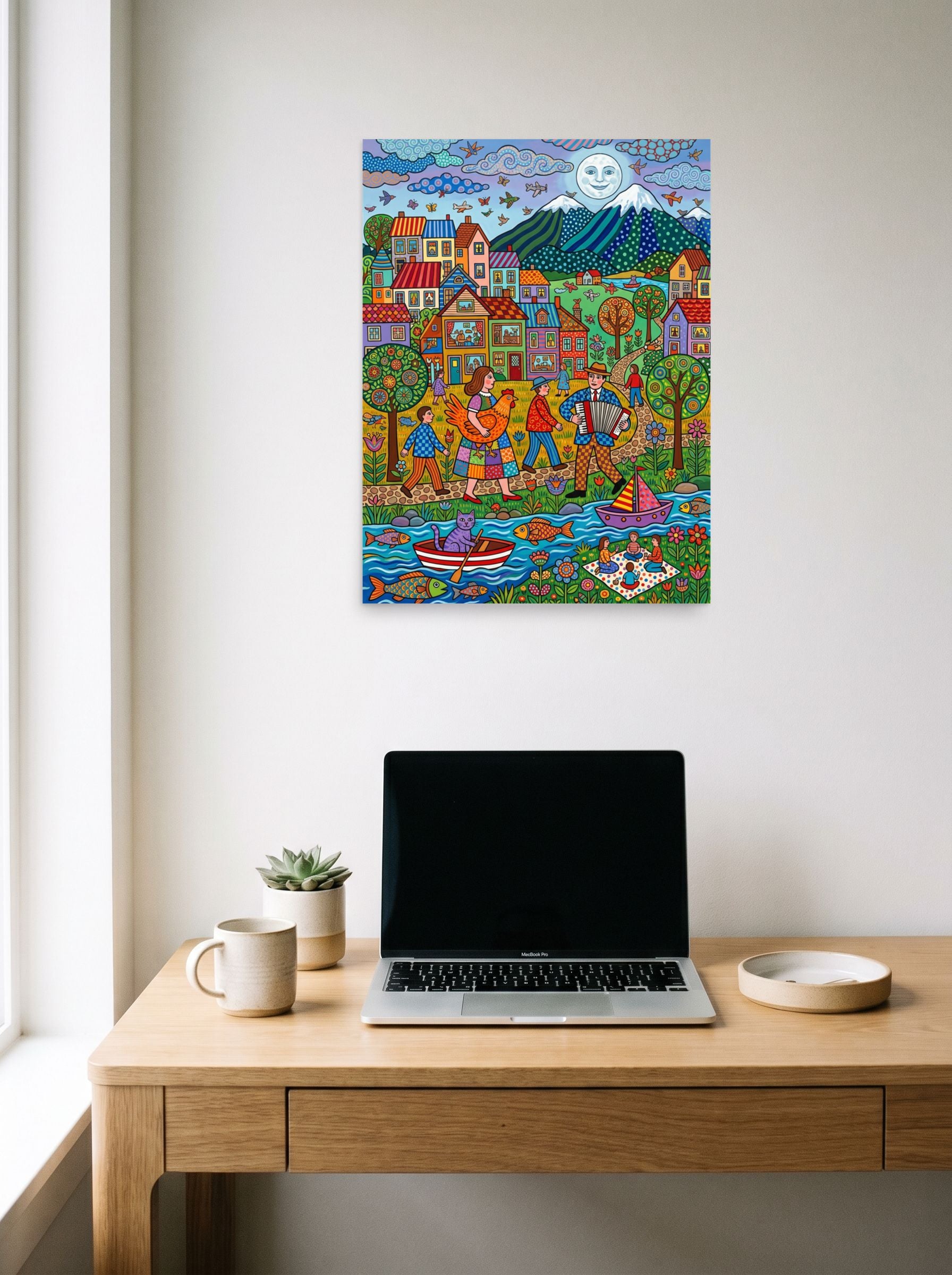 A 18x24 inch unframed paper Naive art print of 'Moonlit Melody By The River' hanging above a worktable with a laptop.