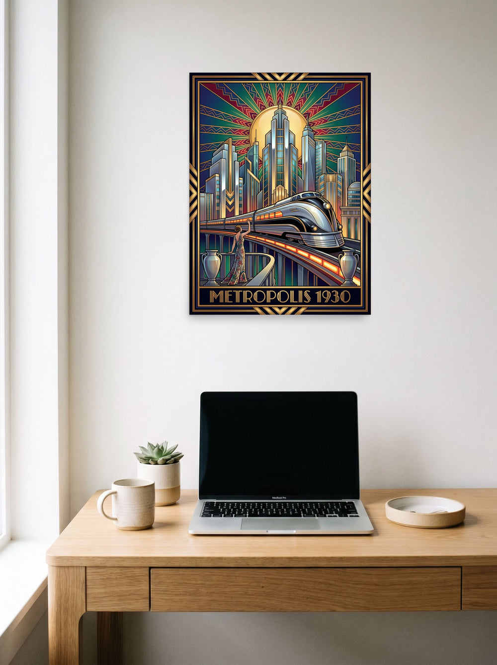 A 18x24 inch unframed paper Art Deco print of 'Monochrome Metropolis' hanging above a worktable with a laptop.