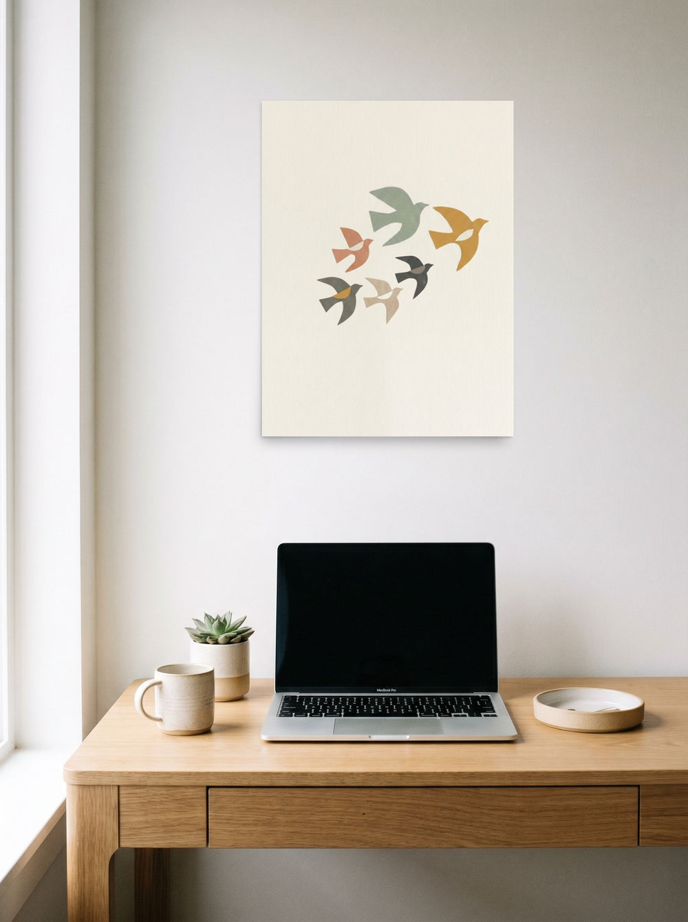 A 18x24 inch unframed paper Minimalism,Abstract art print of 'The Minimalist Flock' hanging above a worktable with a laptop.