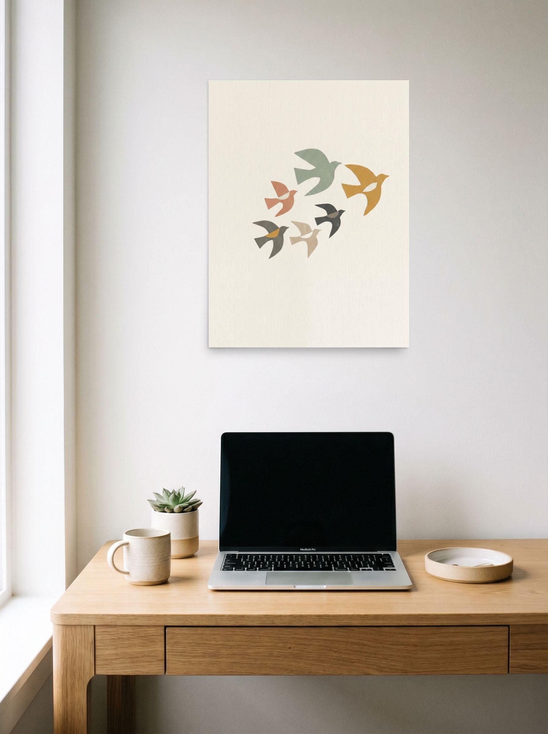 A 18x24 inch unframed paper Minimalism,Abstract art print of 'The Minimalist Flock' hanging above a worktable with a laptop.