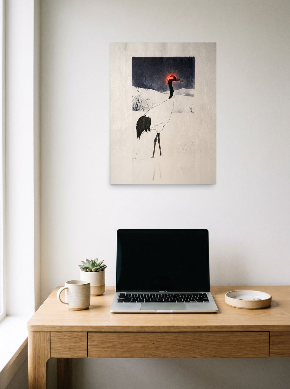A 18x24 inch unframed paper Ukiyo-e,Surrealism print of 'Winter Crane's Neon Crown' hanging above a worktable with a laptop.