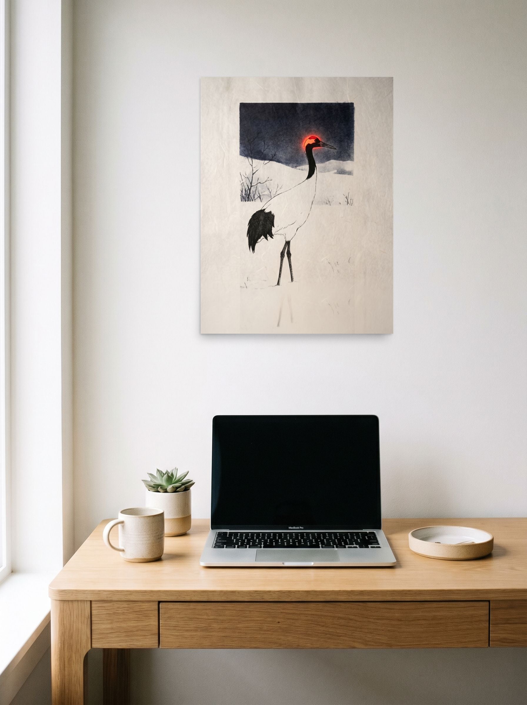 A 18x24 inch unframed paper Ukiyo-e,Surrealism print of 'Winter Crane's Neon Crown' hanging above a worktable with a laptop.