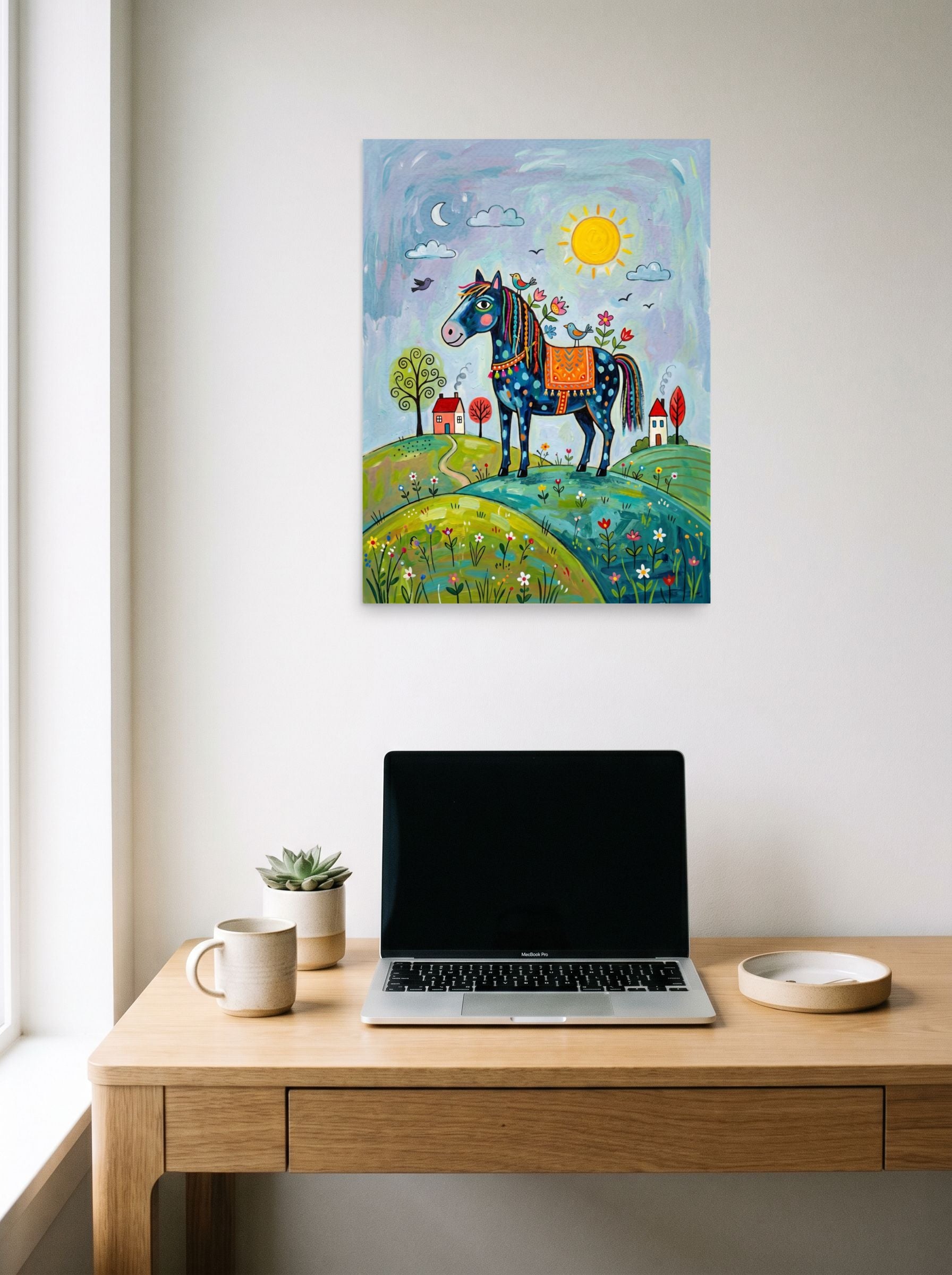 A 18x24 inch unframed paper Naive art print of 'The Starlit Steed' hanging above a worktable with a laptop.