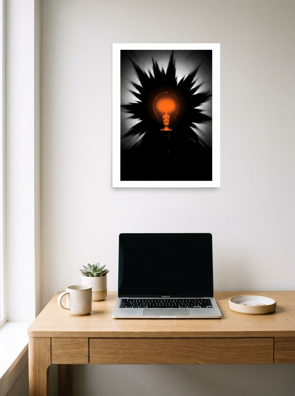 Pop art wall art 'Spark of Innovation', unframed paper at 18x24 inch, hanging above a worktable with a laptop.