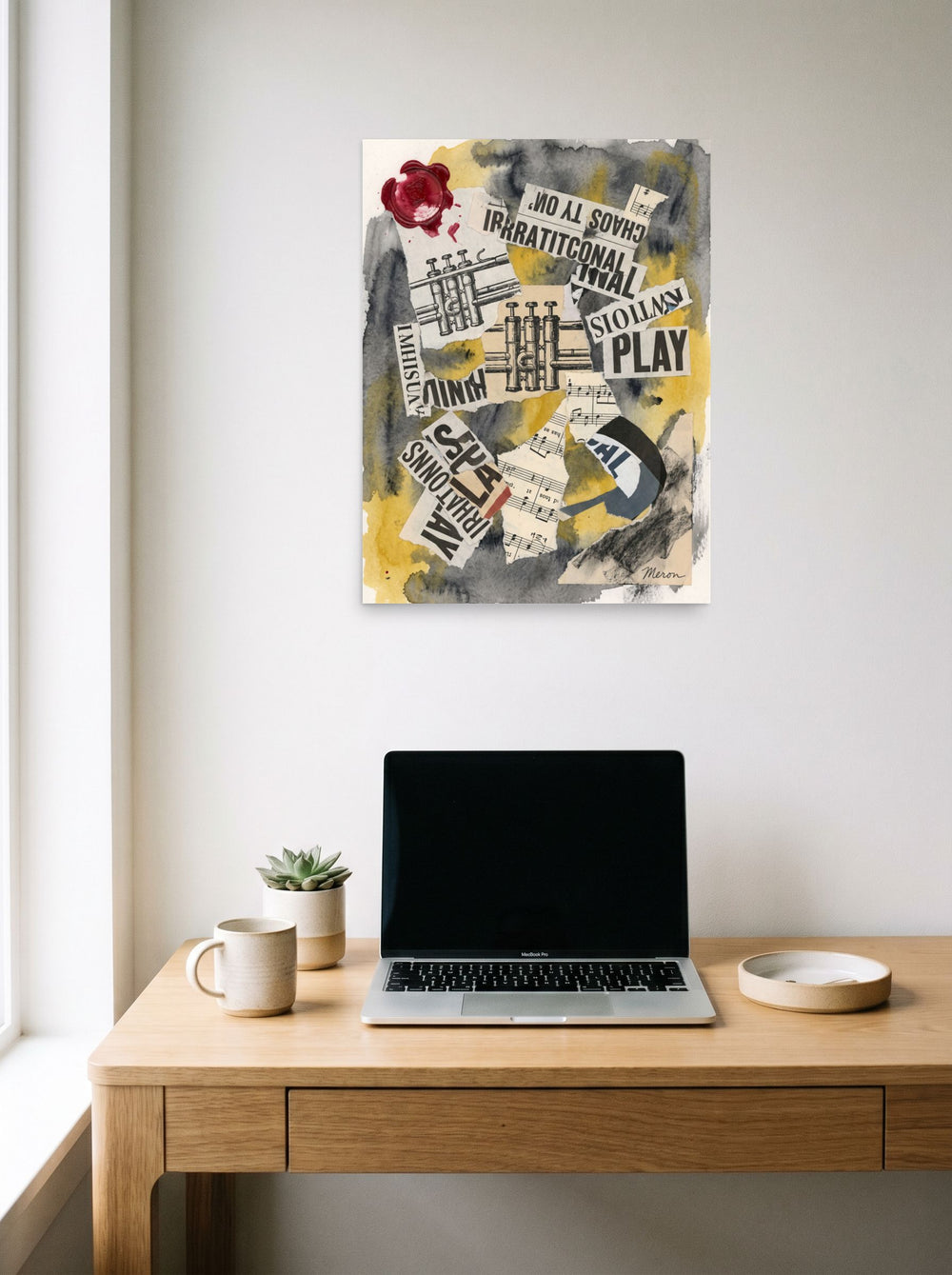 'Irrational Cadence', a Dada print hanging above a worktable with a laptop. Shown as unframed paper, 18x24 inch.
