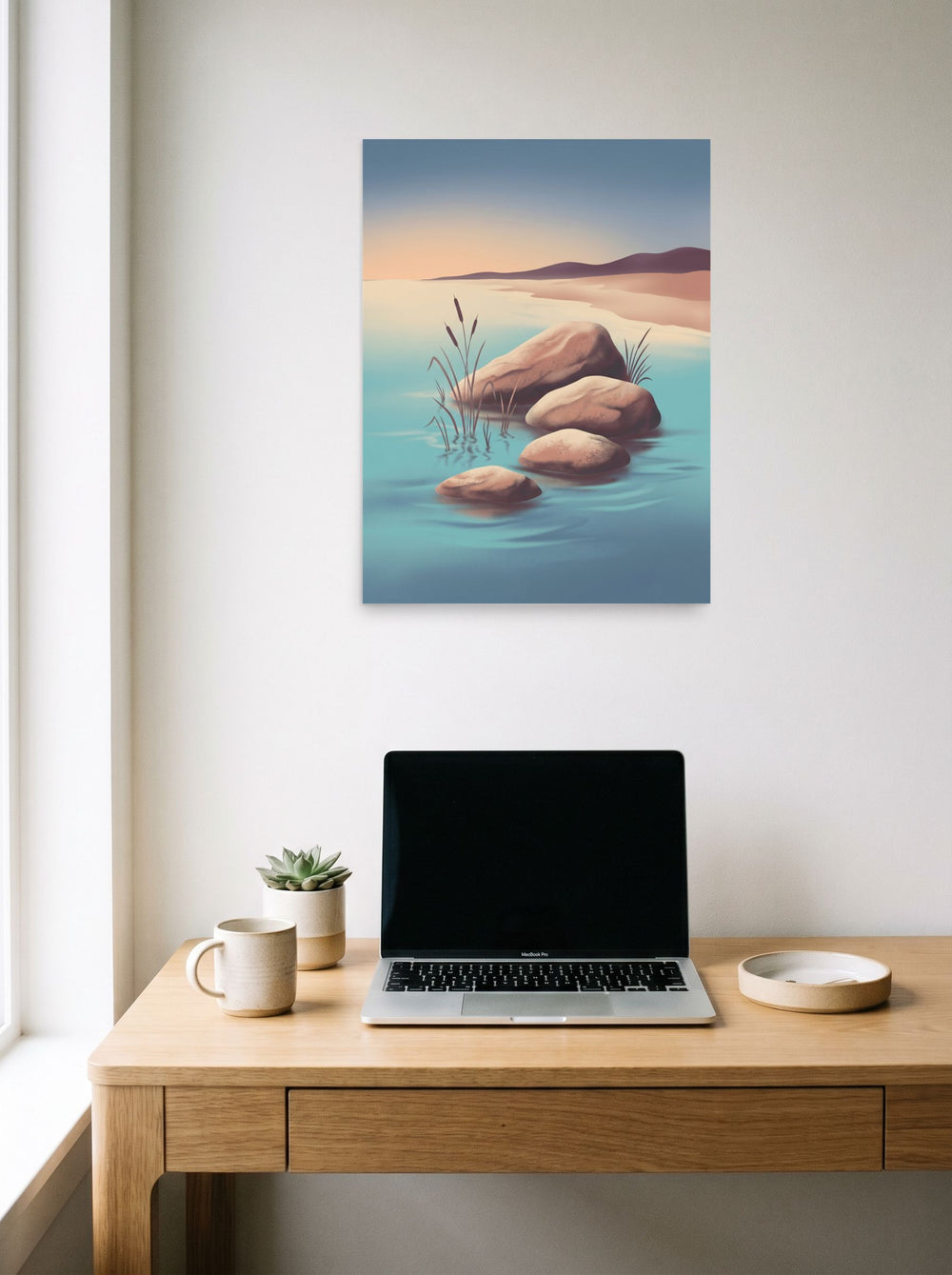 A 18x24 inch unframed paper Minimalism print of 'Zen Waters' hanging above a worktable with a laptop.