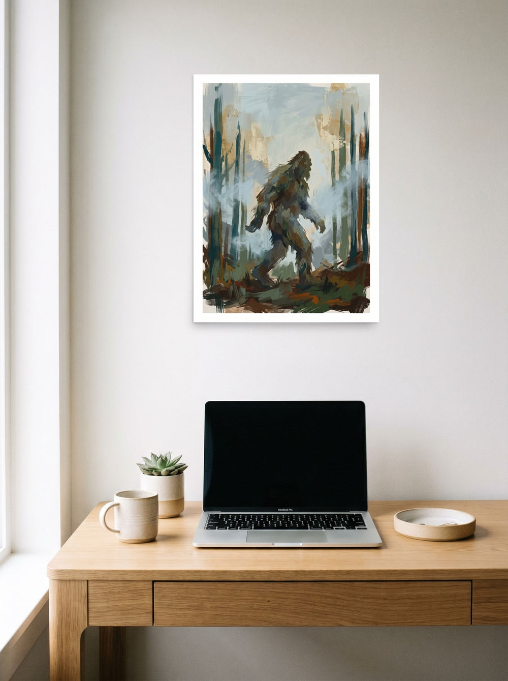 Impressionism wall art 'Shadow of Pines', unframed paper at 18x24 inch, hanging above a worktable with a laptop.