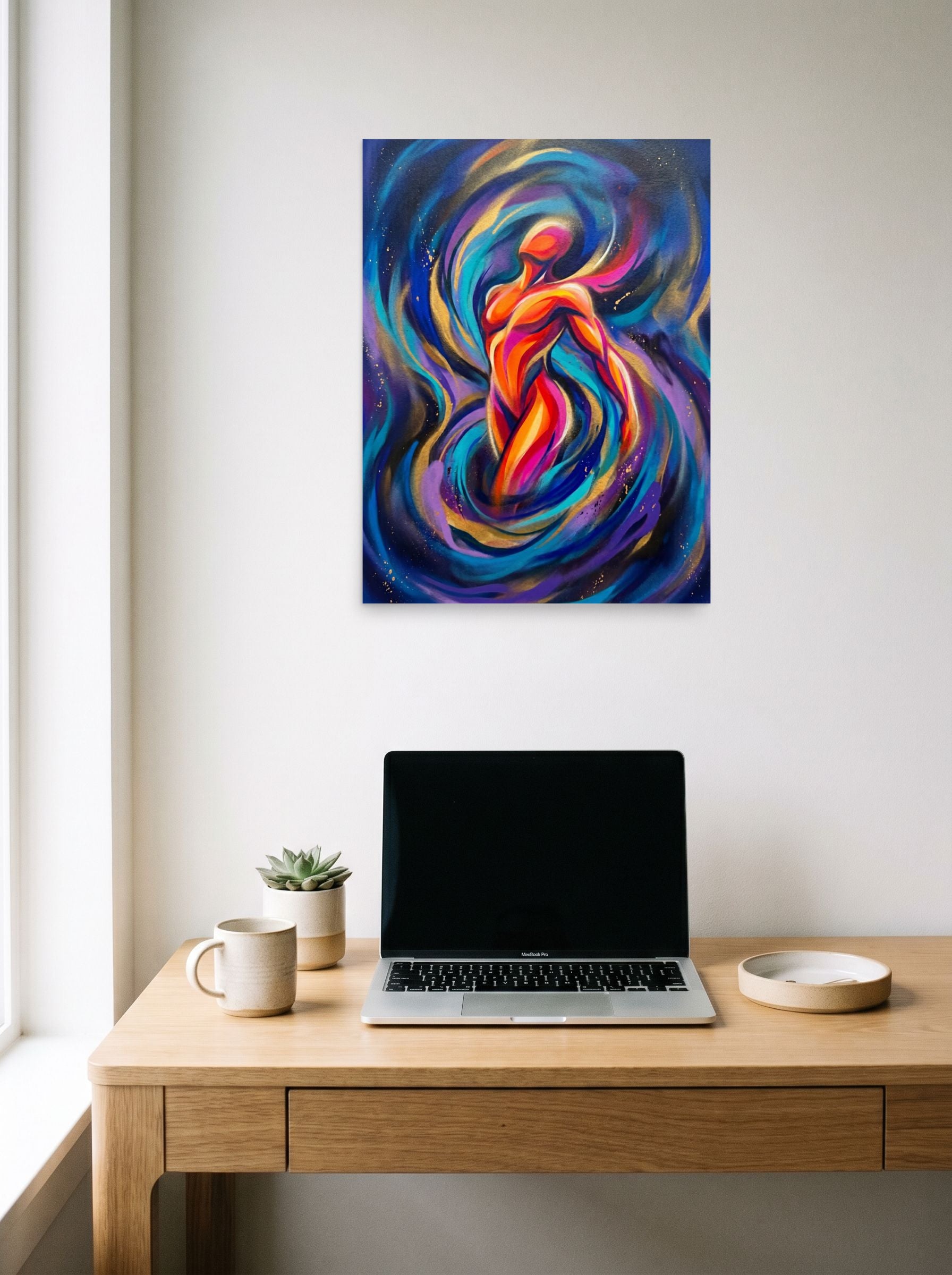 A 18x24 inch unframed paper Psychedelic art print of 'Cosmic Pulse' hanging above a worktable with a laptop.
