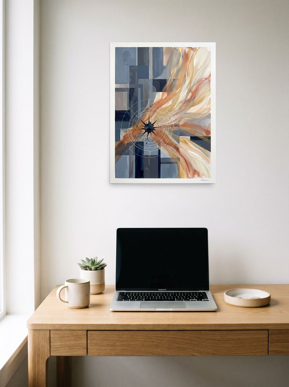 'Celestial Nexus' hanging above a worktable with a laptop. A 18x24 inch unframed paper Geometric abstract art print.