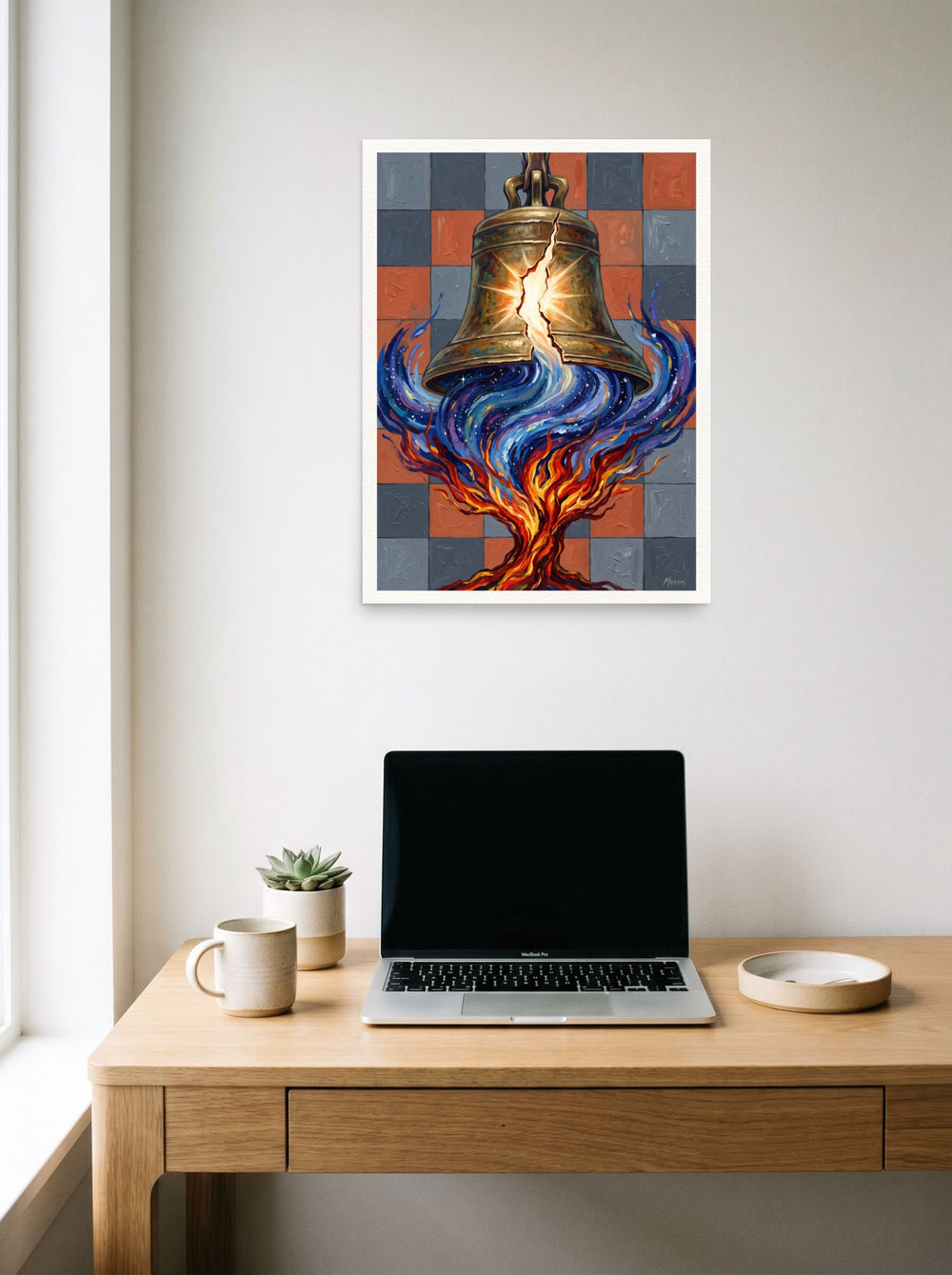 'Resonance of the Fractured Bell' as a unframed paper print, 18x24 inch, hanging above a worktable with a laptop.