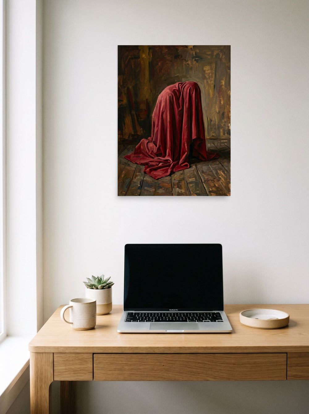 A 18x24 inch unframed paper Baroque,Realism print of 'The Red Drape' hanging above a worktable with a laptop.