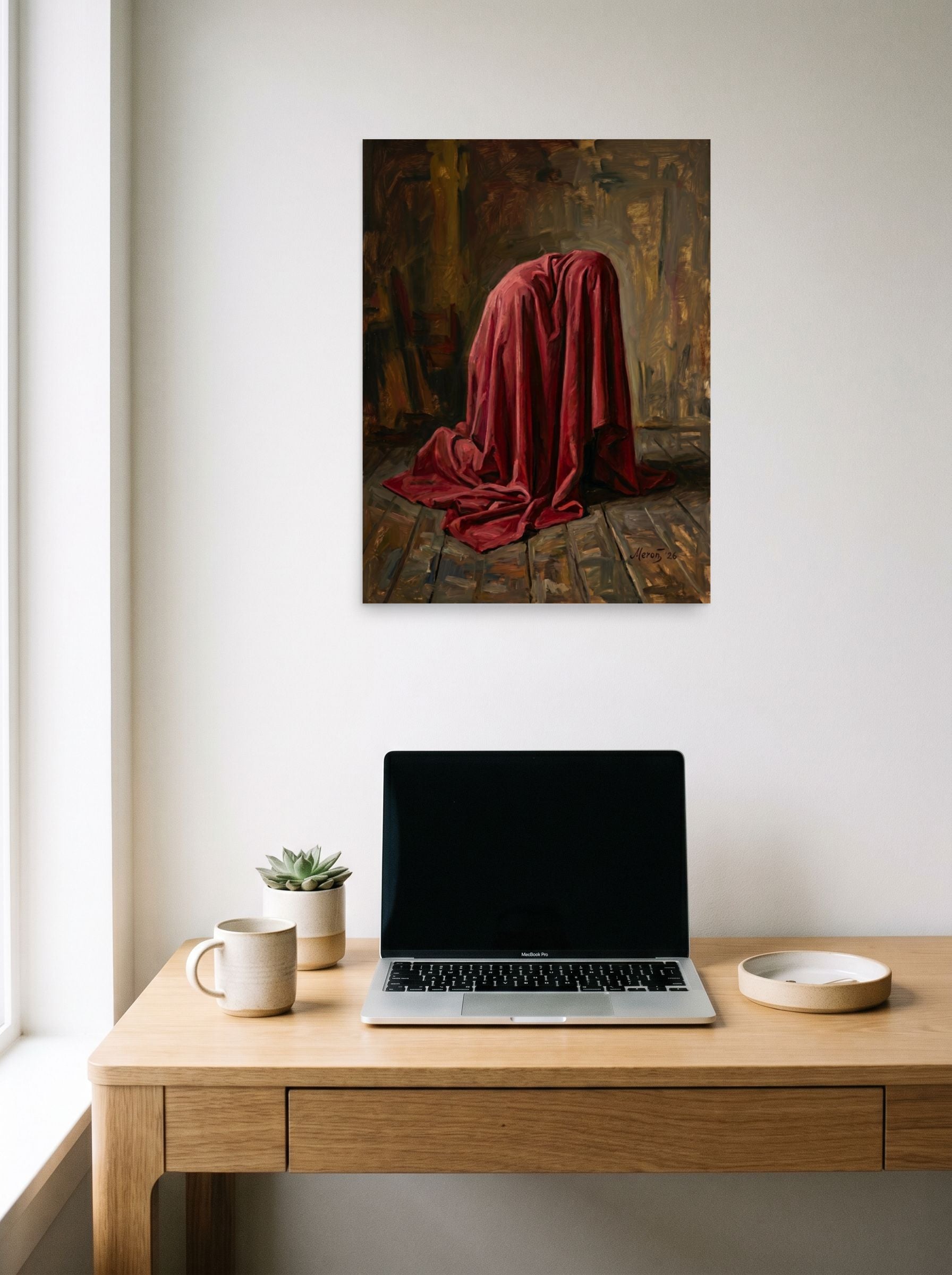 A 18x24 inch unframed paper Baroque,Realism print of 'The Red Drape' hanging above a worktable with a laptop.