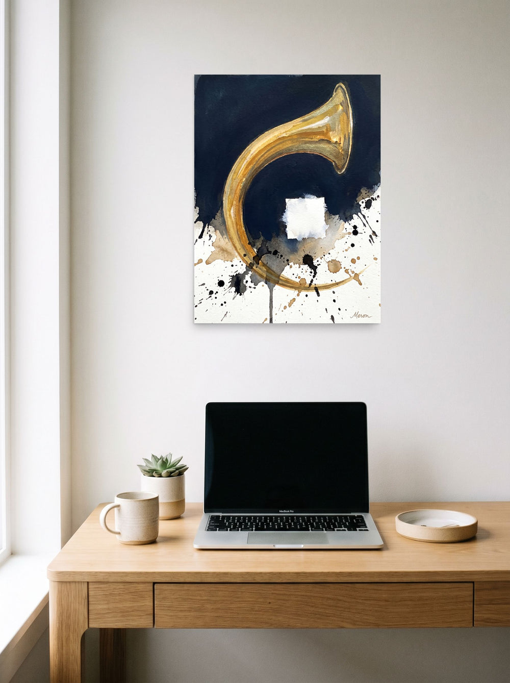 'Crescendo in Gold' hanging above a worktable with a laptop, printed as unframed paper at 18x24 inch.