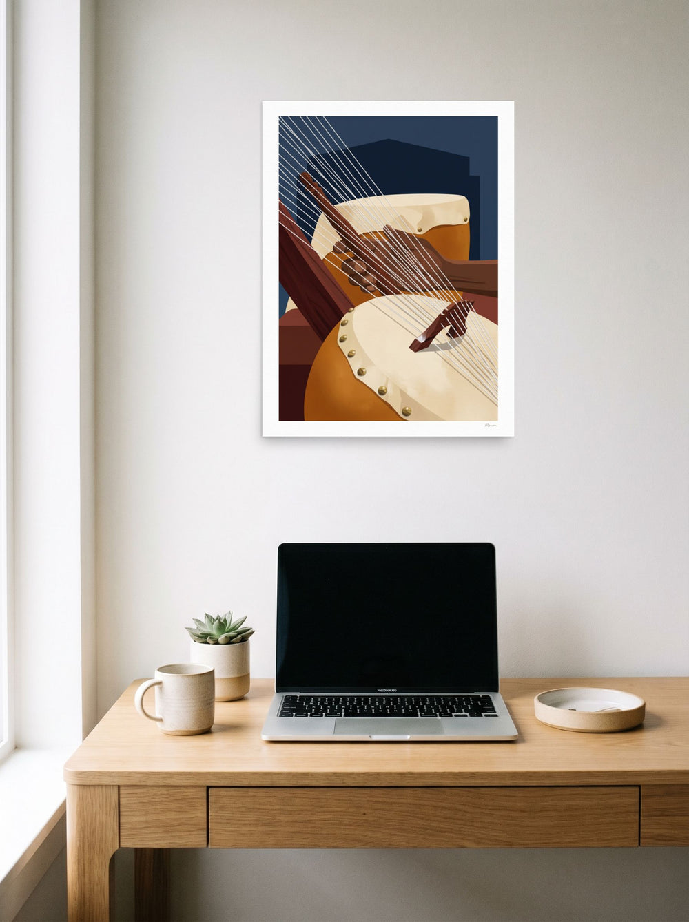 Mockup of 'Strings of the Kora' as a 18x24 inch unframed paper print, displayed over a compact desk setup.