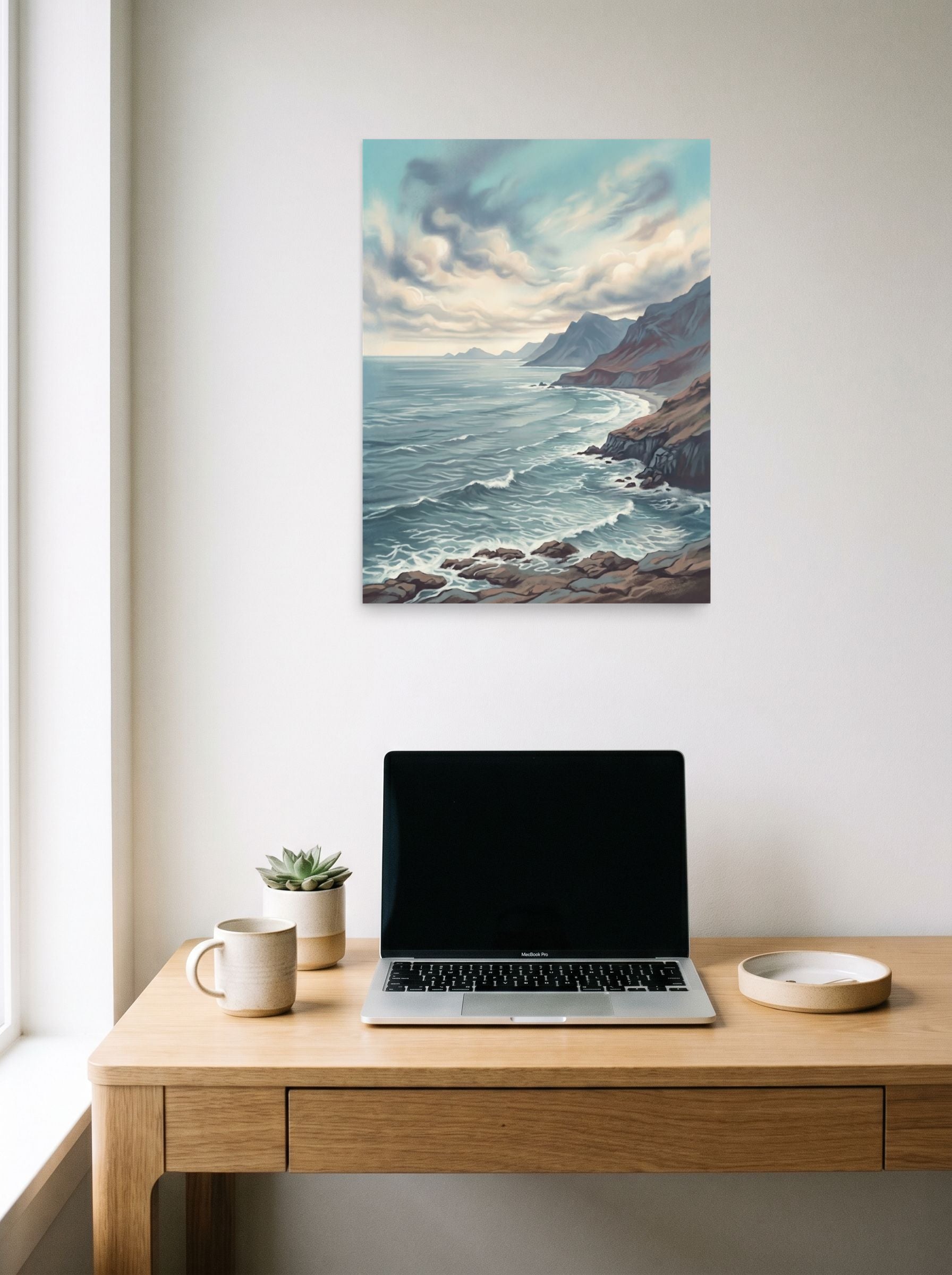 A 18x24 inch unframed paper Romanticism print of 'Coastal Echoes' hanging above a worktable with a laptop.