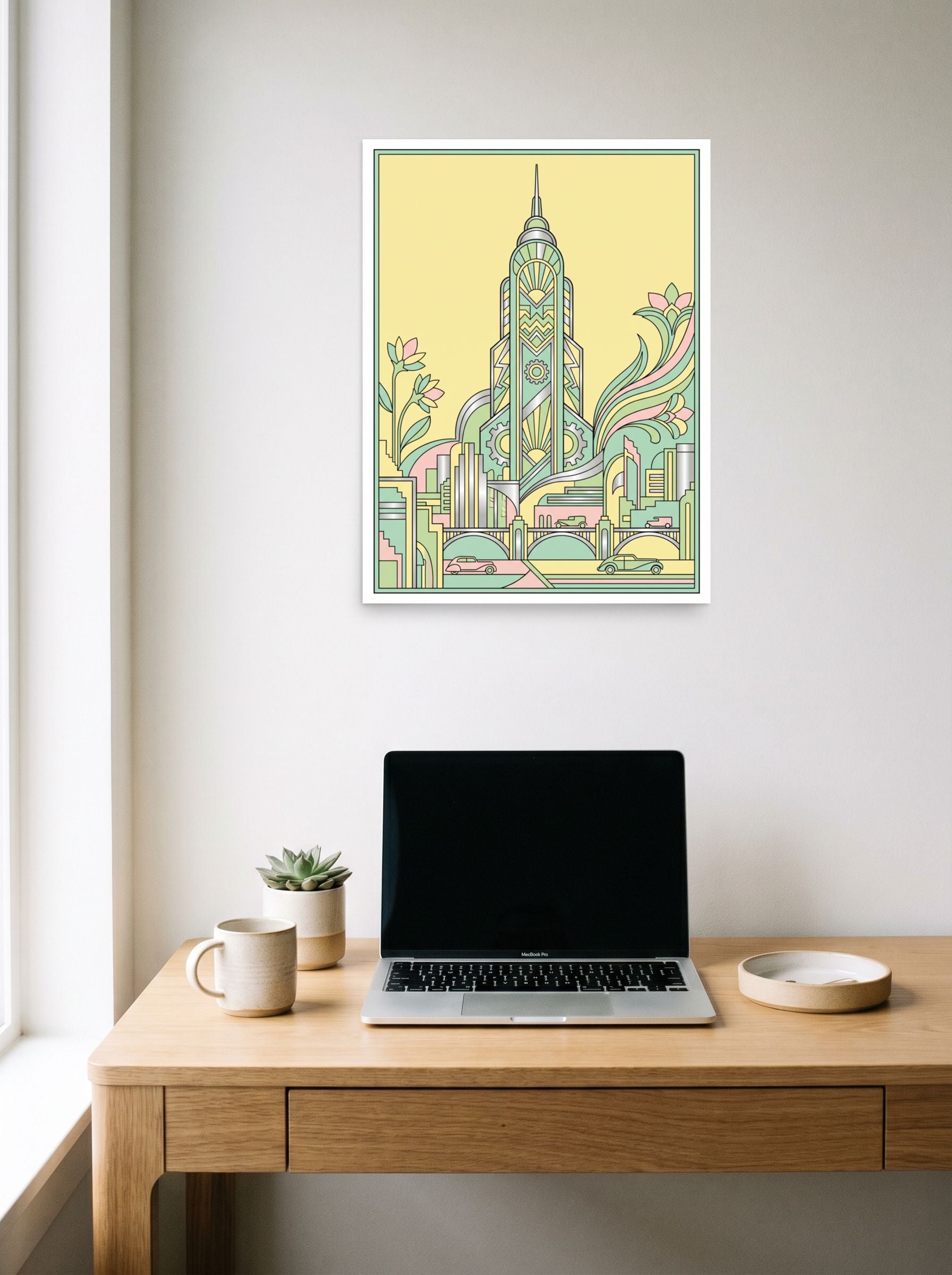 A 18x24 inch unframed paper Art Deco print of 'The Emerald Spire' hanging above a worktable with a laptop.