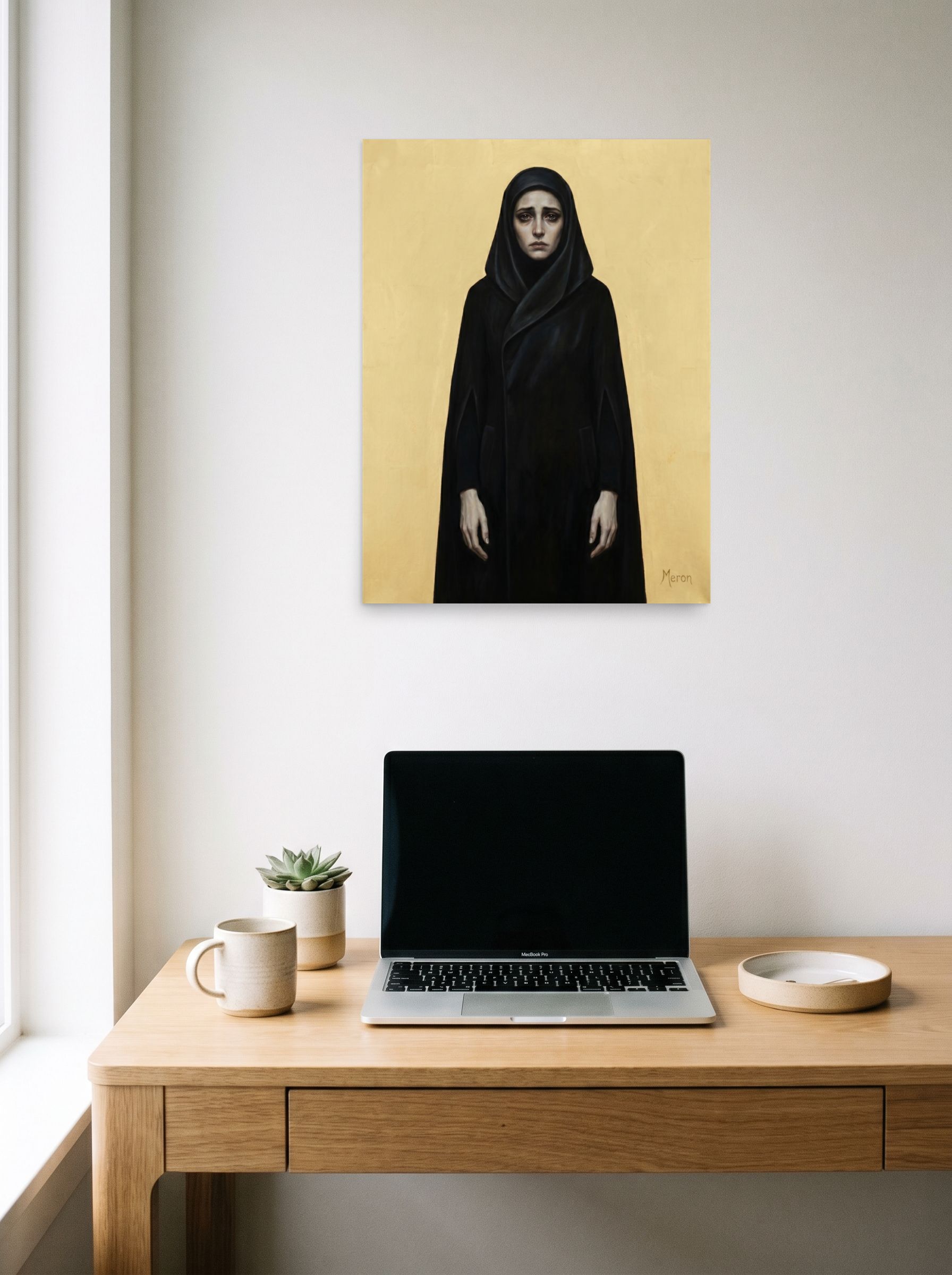 A 18x24 inch unframed paper Figurative art,Symbolism print of 'The Grieving Matriarch' hanging above a worktable with a laptop.