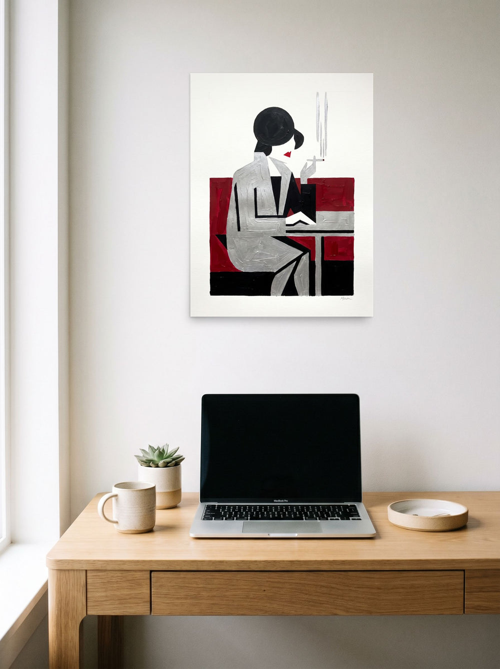 A 18x24 inch unframed paper Art Deco,Cubism print of 'Café Silhouette' hanging above a worktable with a laptop.