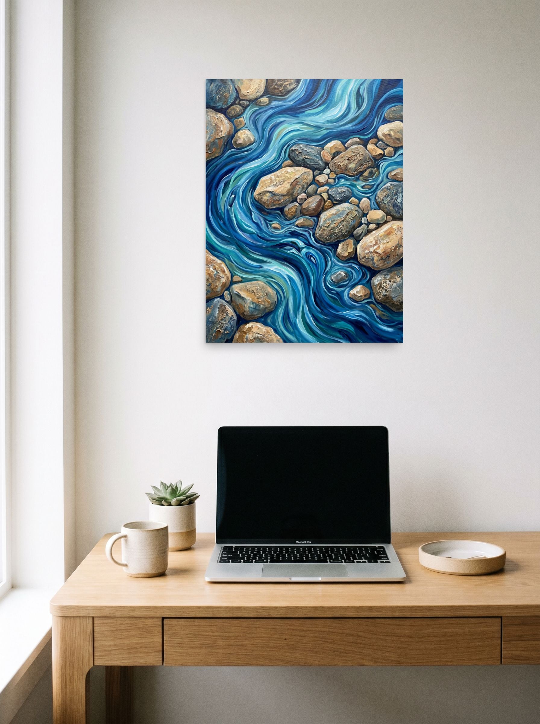 A 18x24 inch unframed paper Abstract expressionism print of 'Riverbed Rhythms' hanging above a worktable with a laptop.