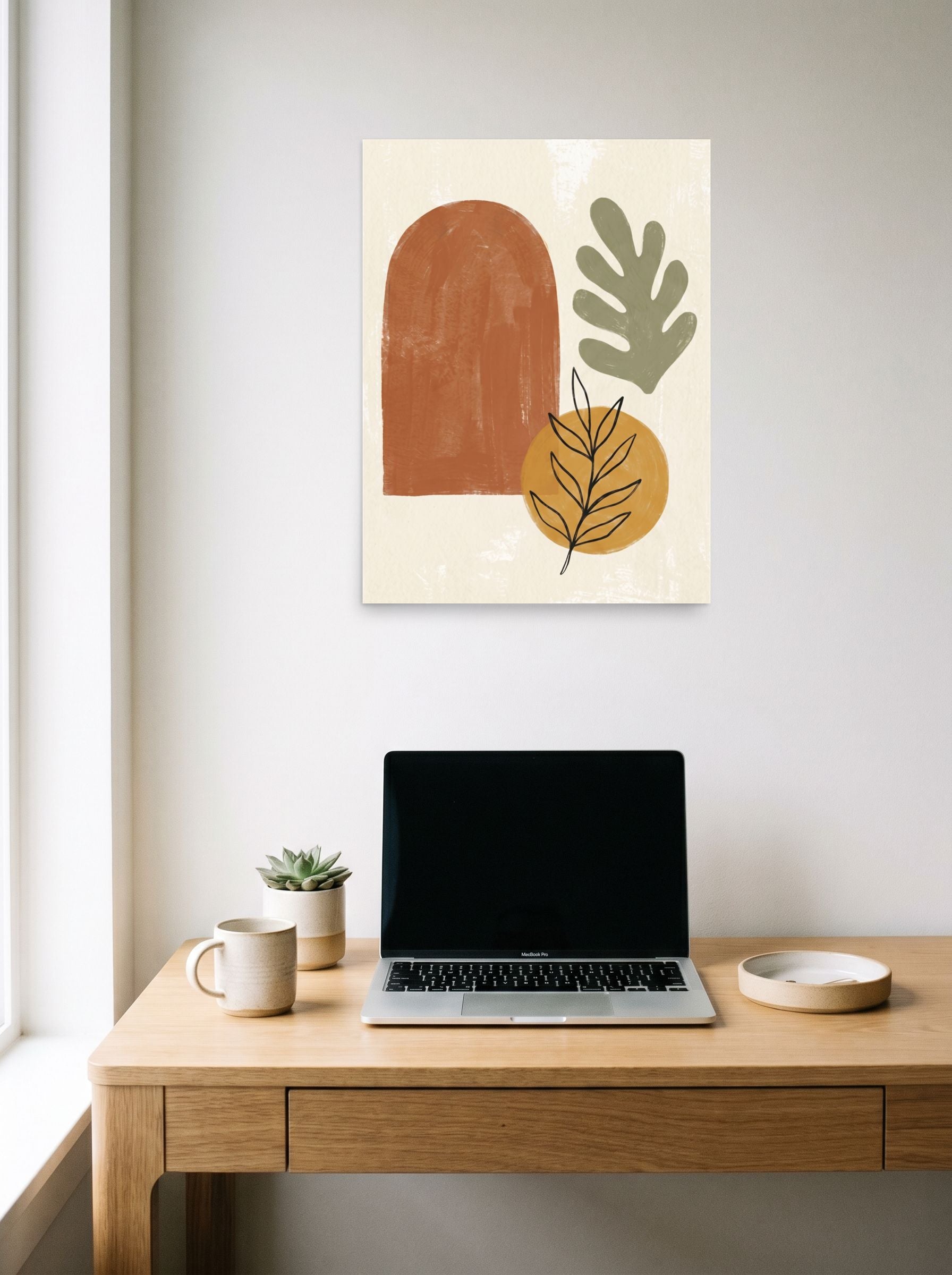 A 18x24 inch unframed paper Minimalism,Abstract art print of 'Botanical Geometry in Earth Tones' hanging above a worktable with a laptop.
