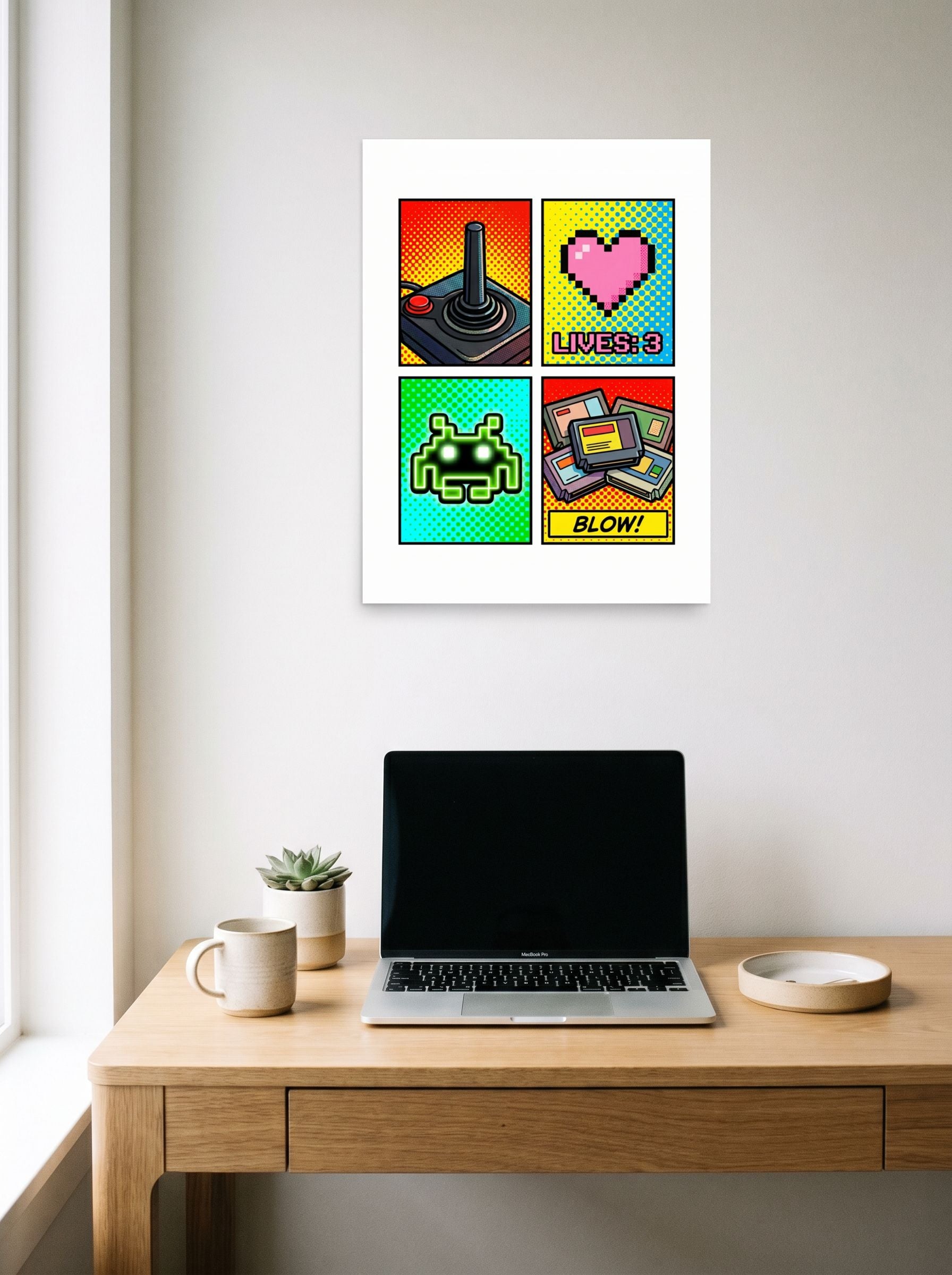 A 18x24 inch unframed paper Pop art print of 'Retro Arcade Memories' hanging above a worktable with a laptop.