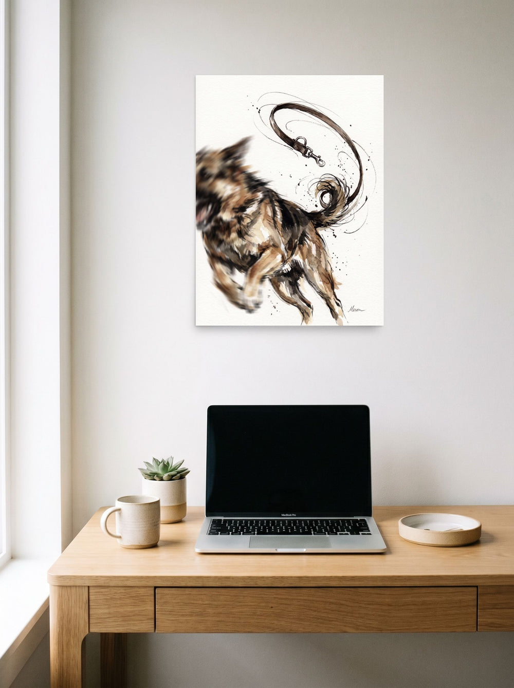 Mockup of 'Unleashed Joy' as a 18x24 inch unframed paper print, hanging above a worktable with a laptop.