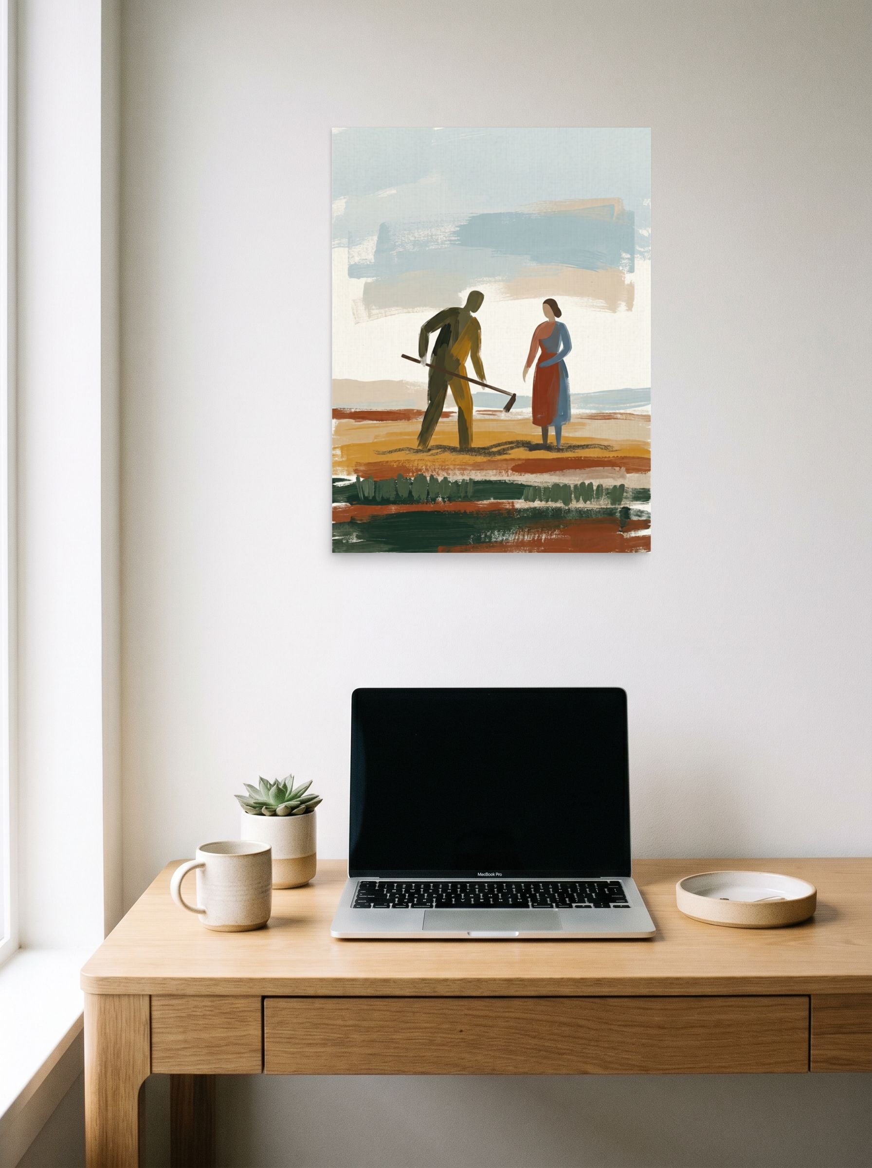 A 18x24 inch unframed paper Expressionism,Figurative art print of 'Tilling the Earth' hanging above a worktable with a laptop.