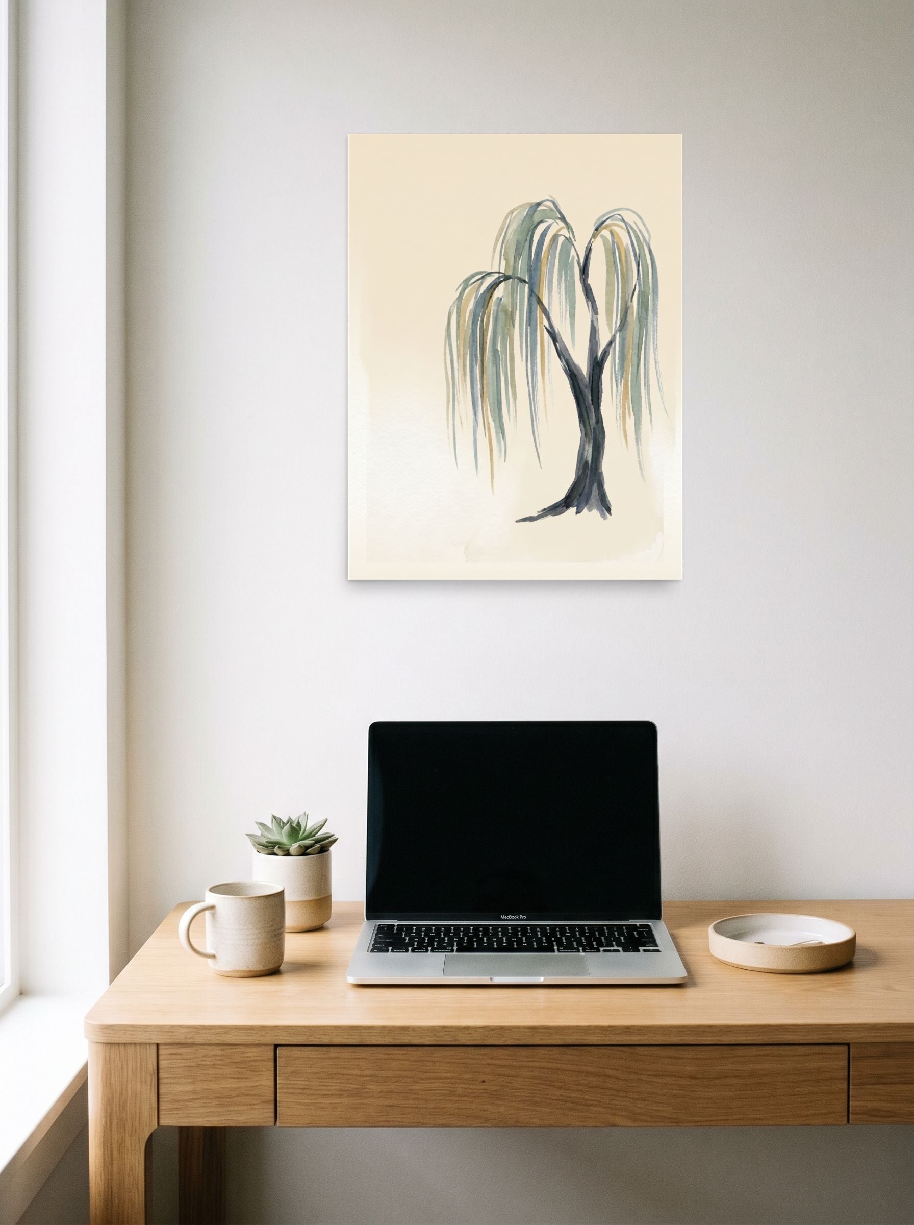 A 18x24 inch unframed paper Minimalism,Japanese art print of 'Weeping Willow Grace' hanging above a worktable with a laptop.