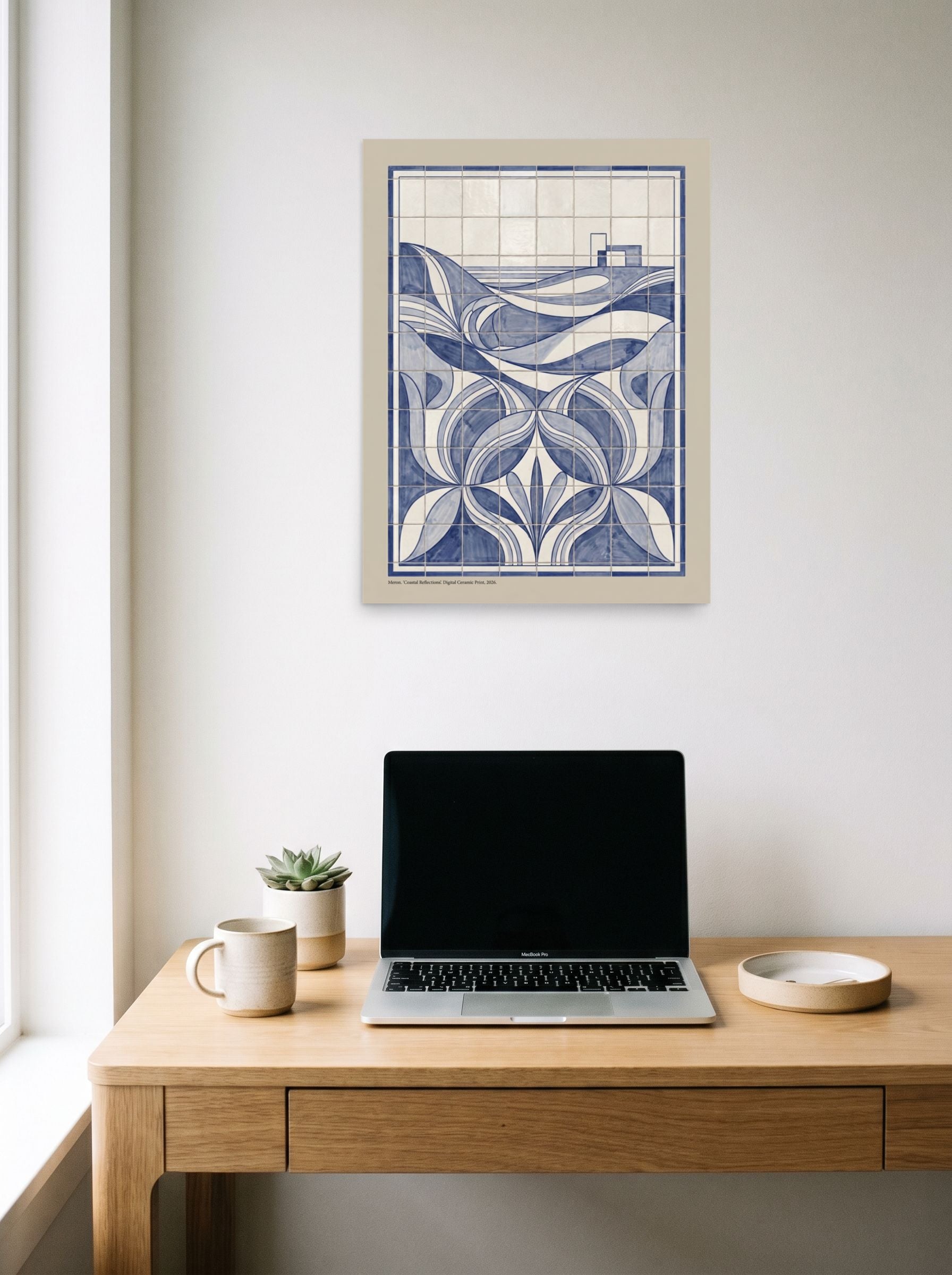 A 18x24 inch unframed paper Art Deco print of 'Coastal Reflections' hanging above a worktable with a laptop.