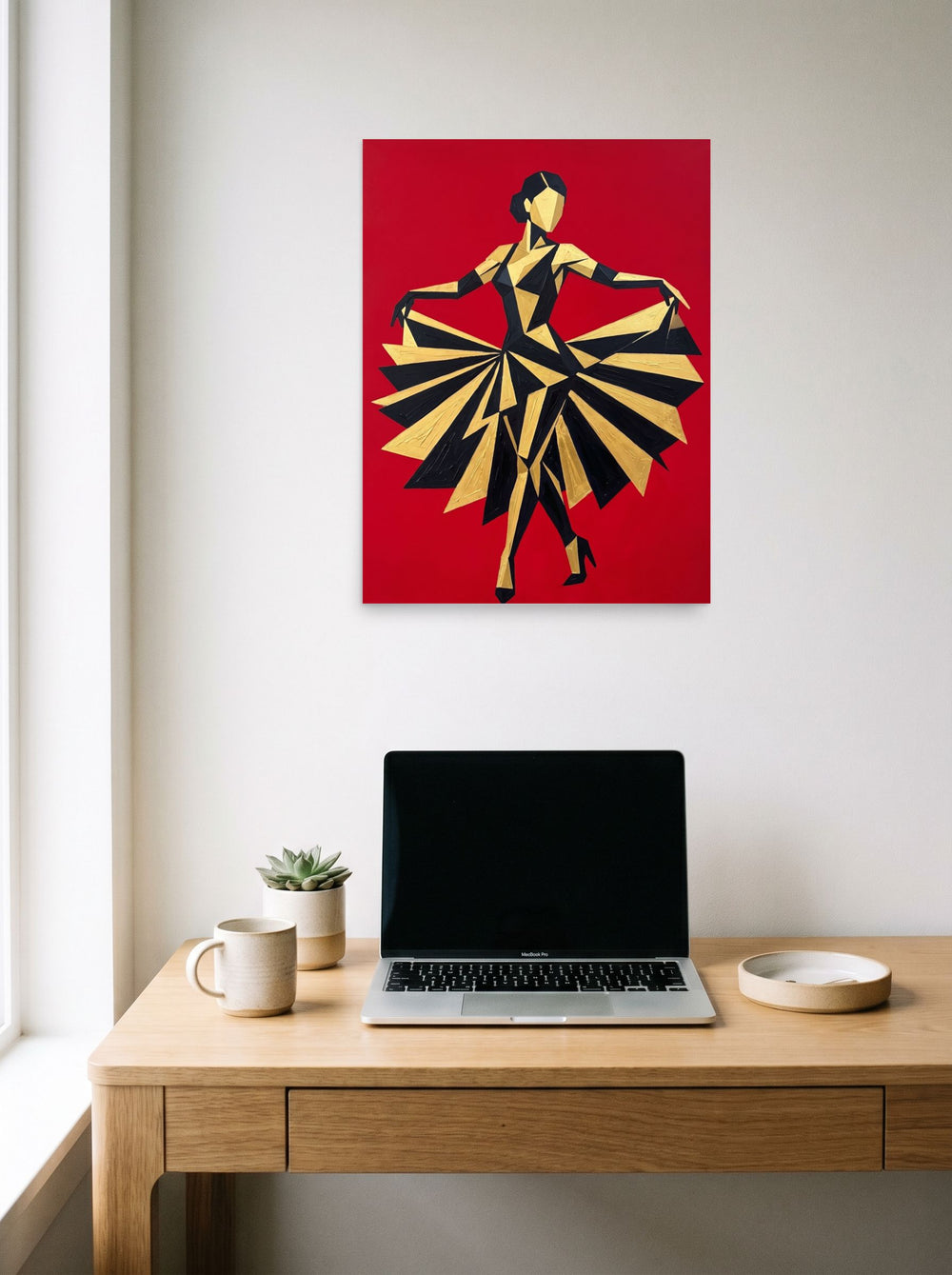 A 18x24 inch unframed paper Art Deco,Cubism print of 'The Golden Dancer' hanging above a worktable with a laptop.