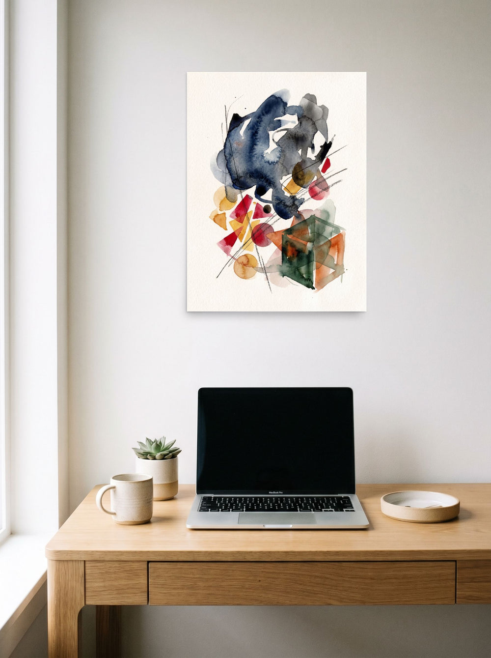 'Geometric Whispers' hanging above a worktable with a laptop. A 18x24 inch unframed paper Dau-al-Set print.