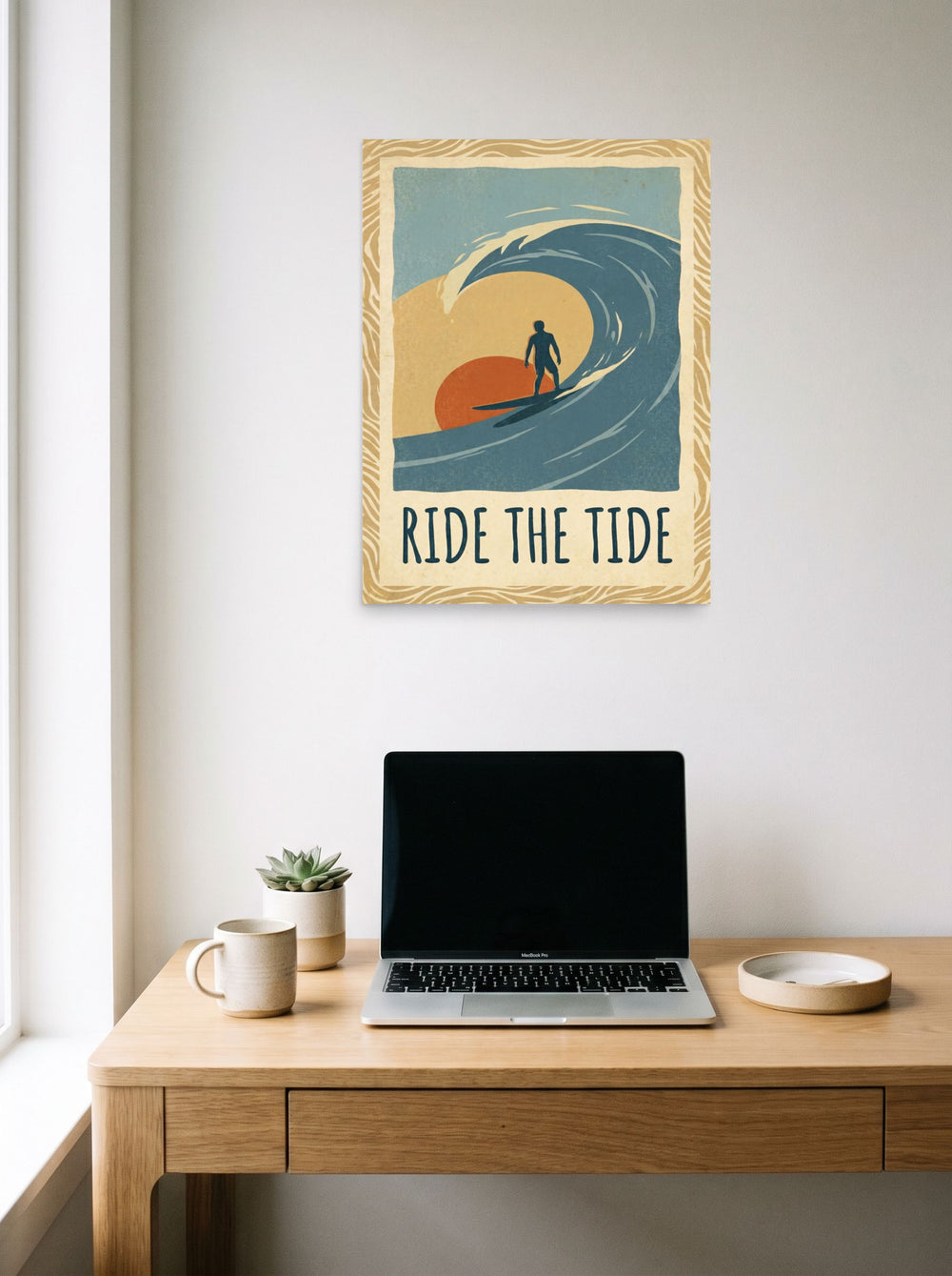 A 18x24 inch unframed paper Pop art,Digital art print of 'Ride the Tide' hanging above a worktable with a laptop.