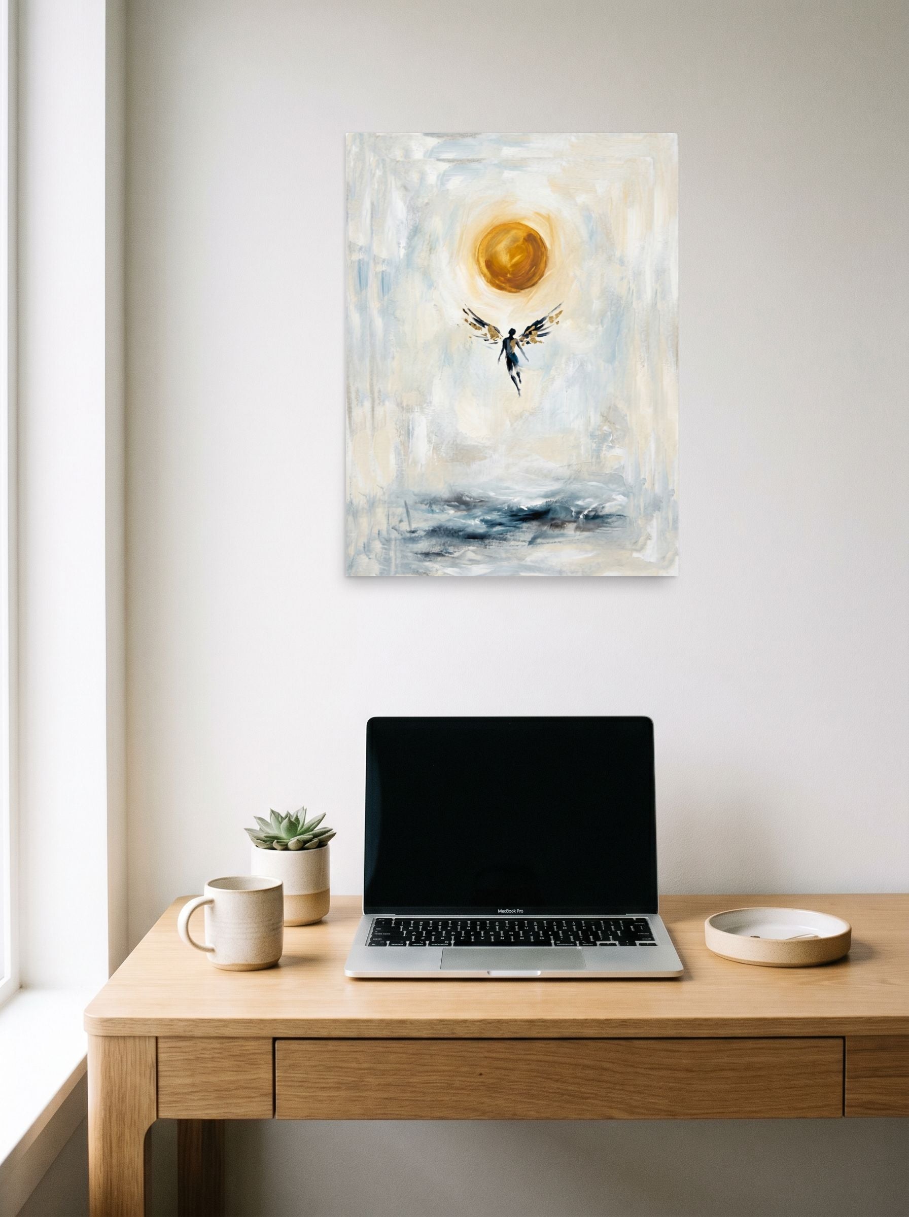 A 18x24 inch unframed paper Expressionism,Symbolism print of 'Icarus Ascending' hanging above a worktable with a laptop.
