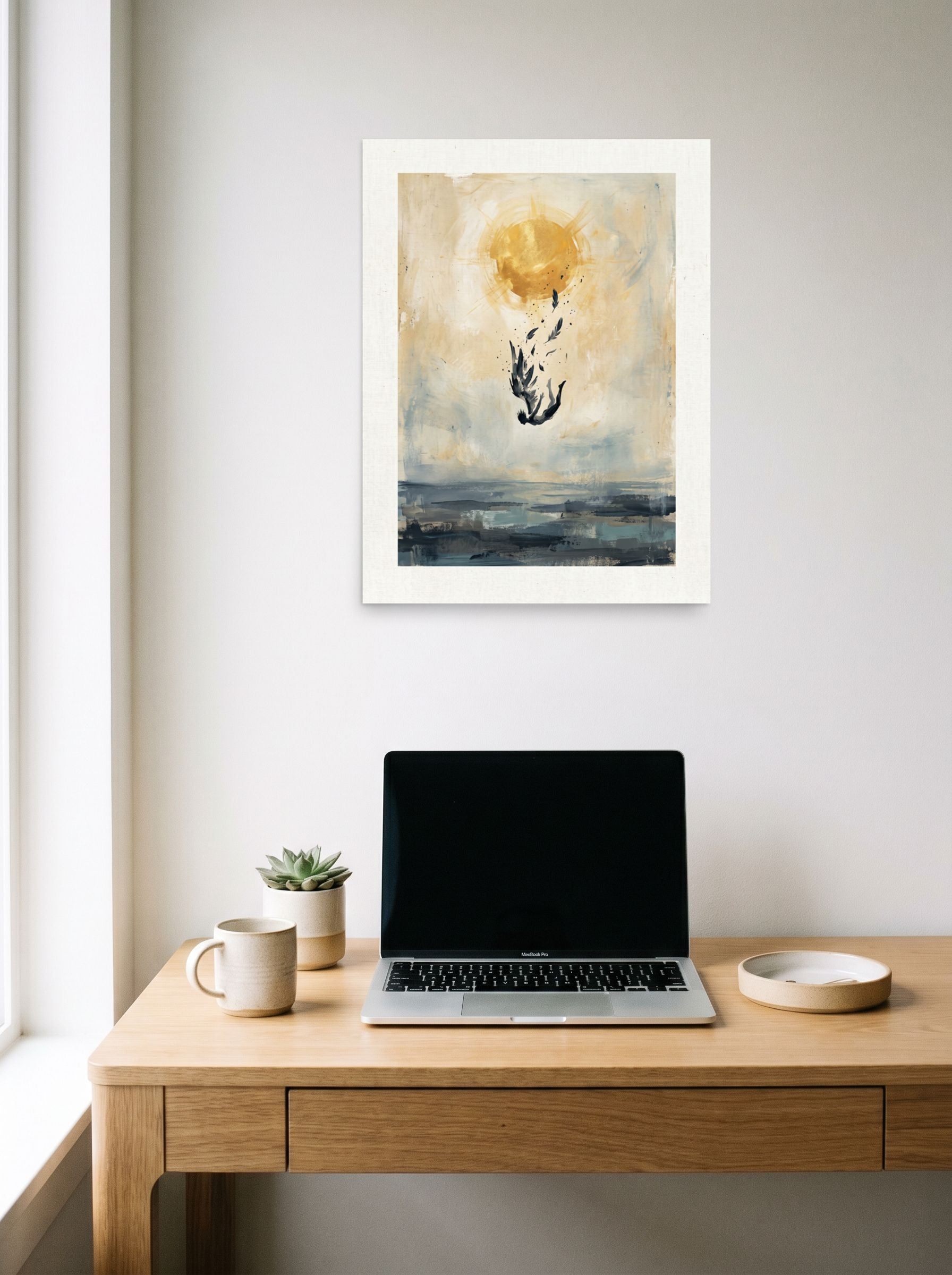 A 18x24 inch unframed paper Expressionism,Symbolism print of 'Icarus Falling' hanging above a worktable with a laptop.