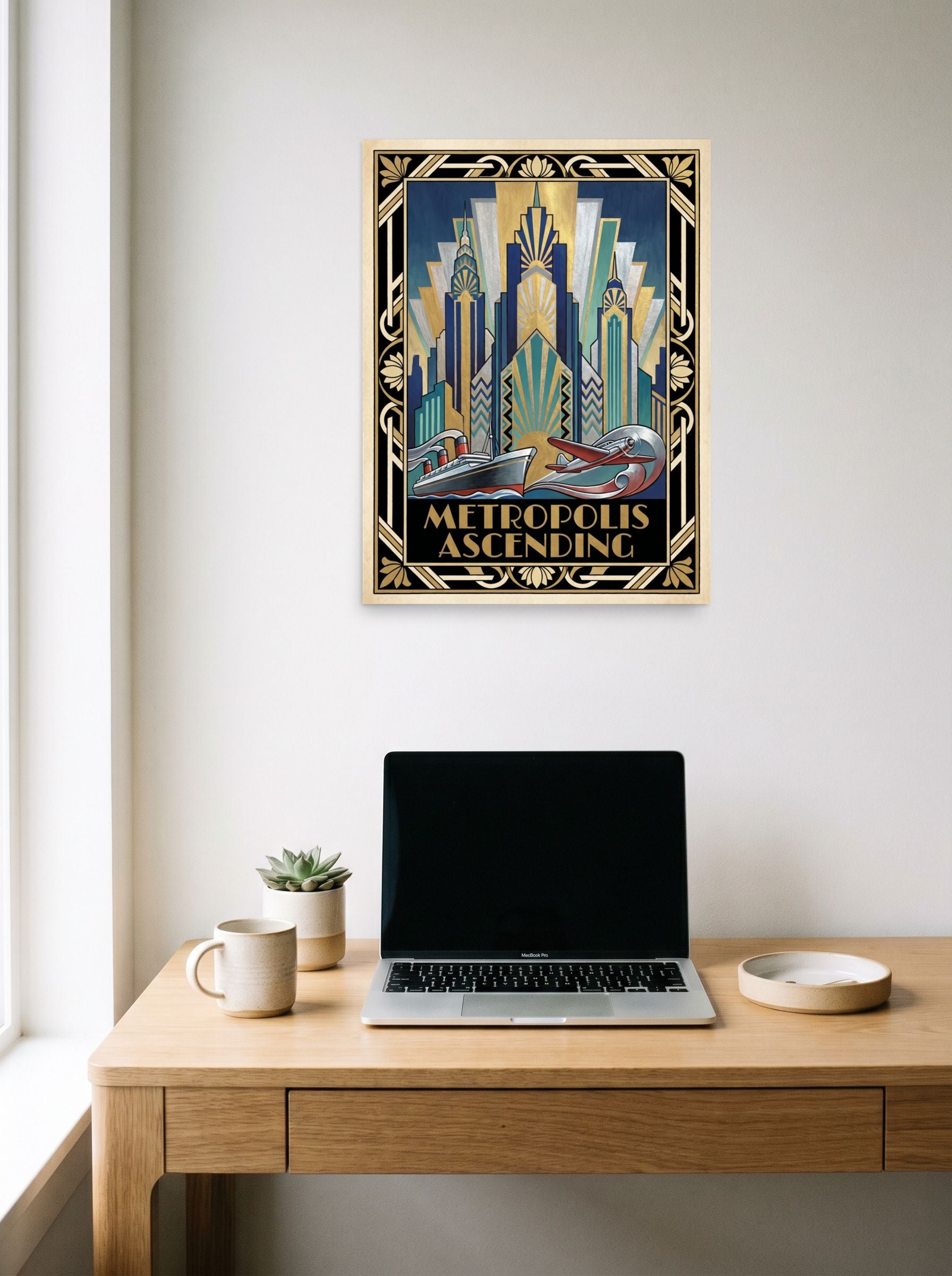 A 18x24 inch unframed paper Art Deco print of 'Metropolis Ascending' hanging above a worktable with a laptop.
