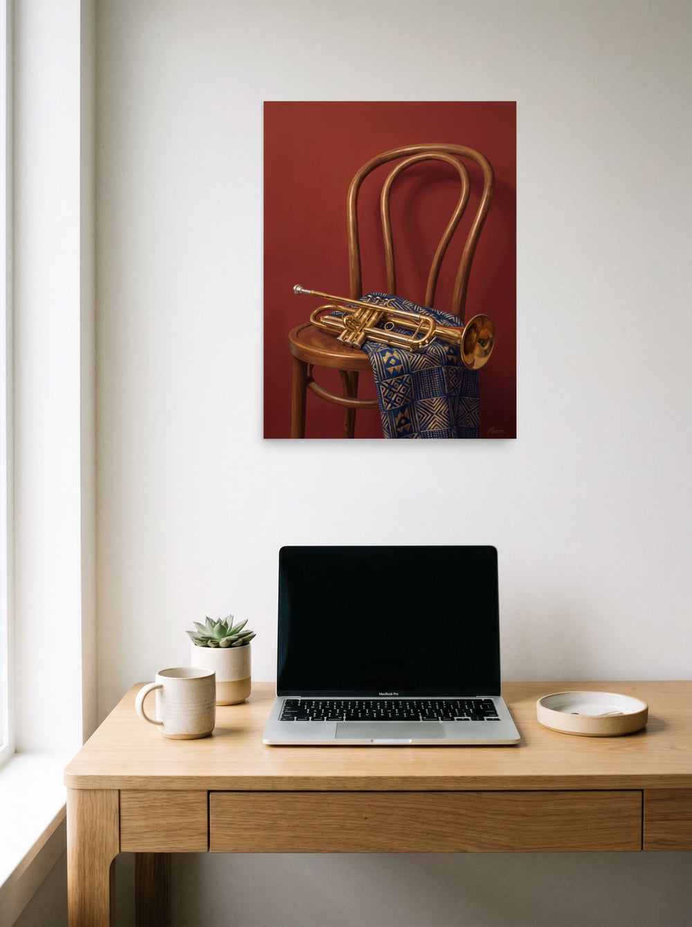 A 18x24 inch unframed paper Realism,Modernism print of 'Brass and Indigo' hanging above a worktable with a laptop.