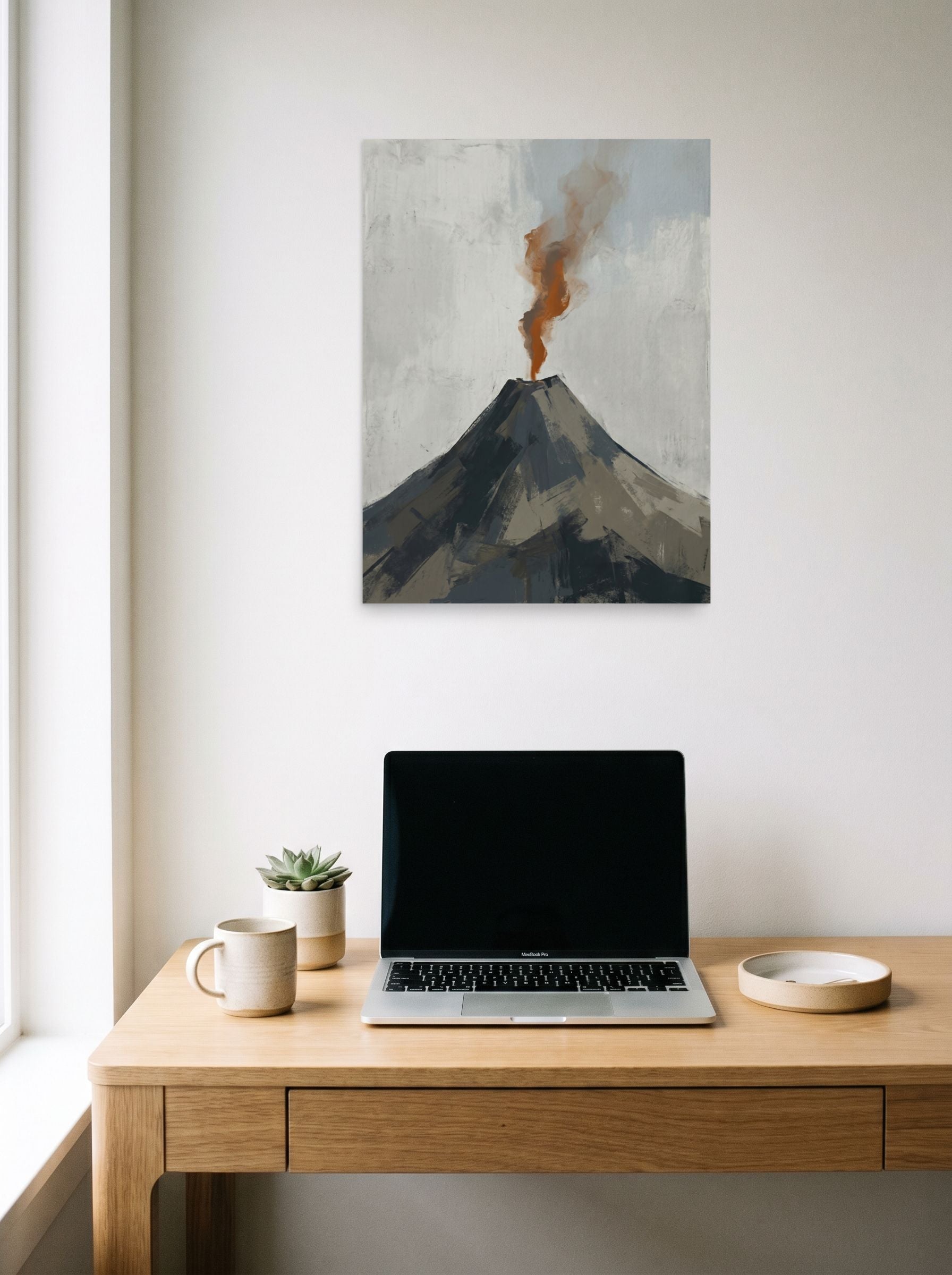 A 18x24 inch unframed paper Minimalism print of 'Earth's Exhale' hanging above a worktable with a laptop.