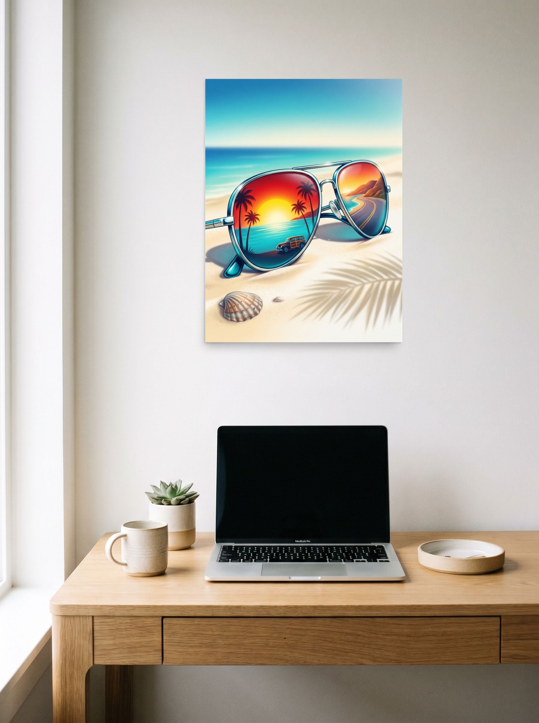 A 18x24 inch unframed paper Photorealism print of 'Sunset Reflections' hanging above a worktable with a laptop.