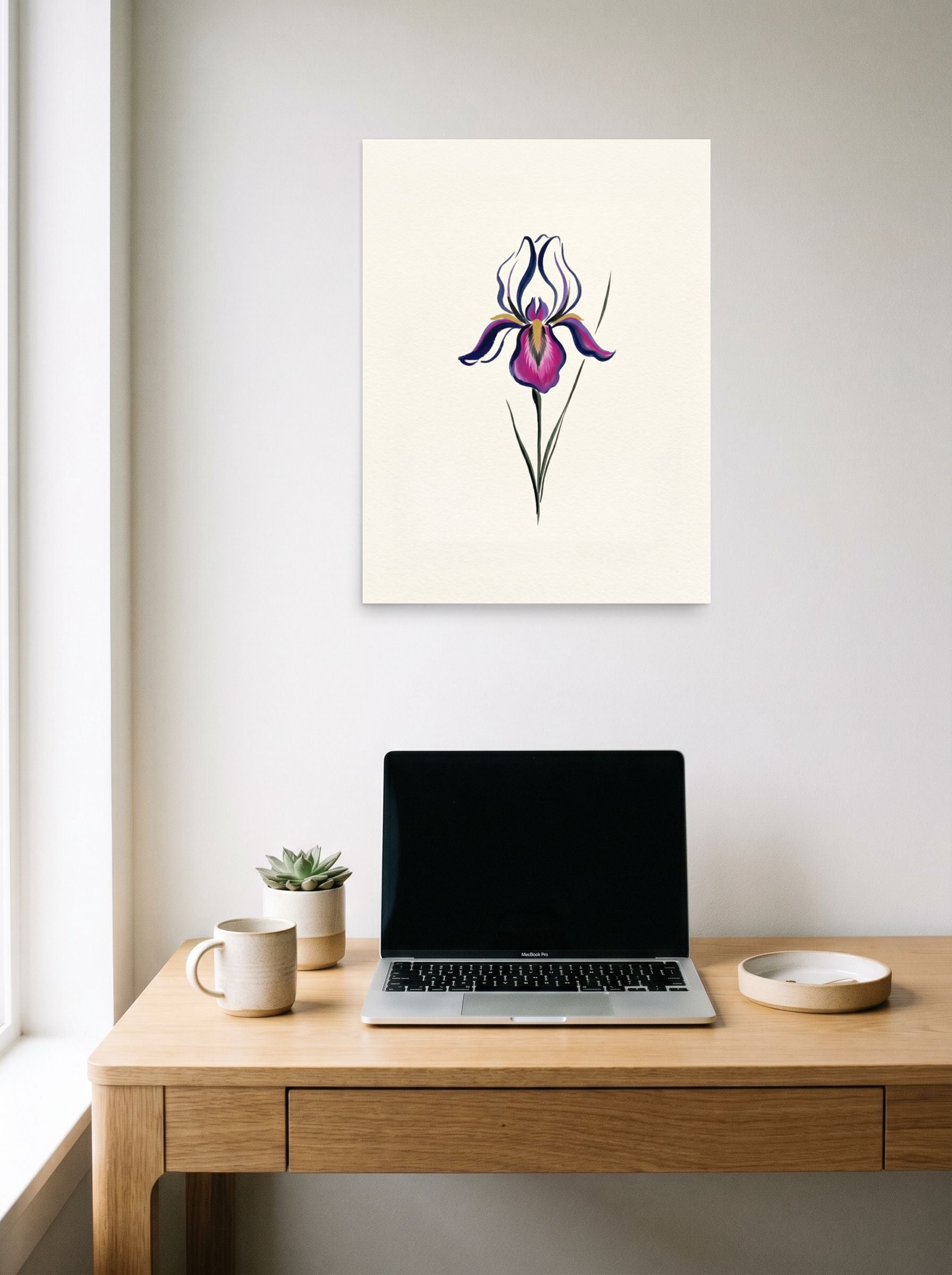 A 18x24 inch unframed paper Minimalism print of 'Iris in Bloom' hanging above a worktable with a laptop.