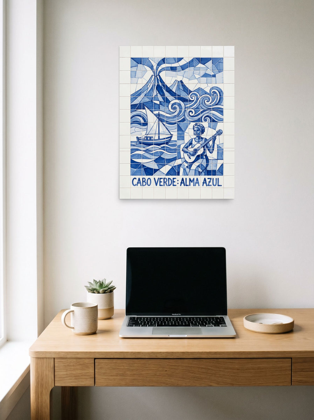 A 18x24 inch unframed paper Cubism print of 'Alma Azul' hanging above a worktable with a laptop.