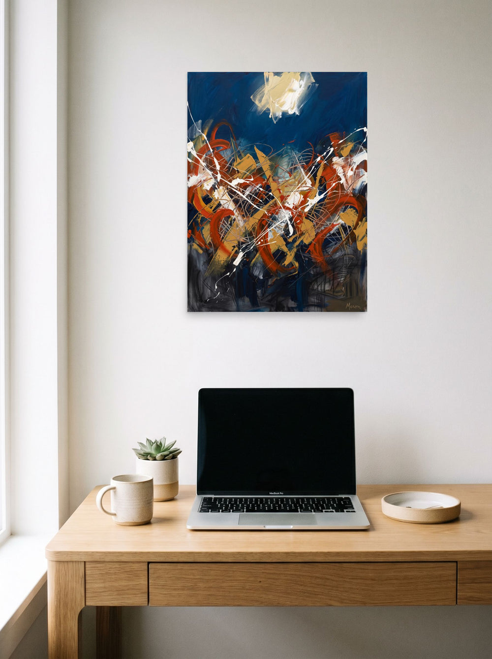 Mockup of 'Midnight Tempest' as a 18x24 inch unframed paper print, hanging above a worktable with a laptop.
